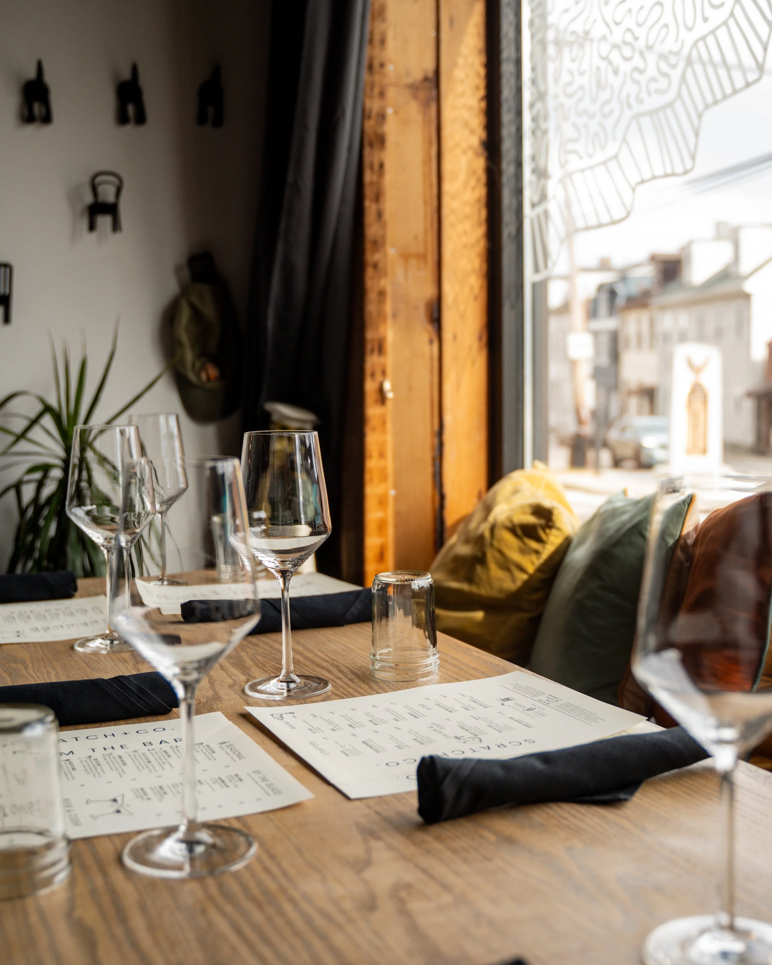 Private dining table set with wine glasses and black napkins, ready for guests
