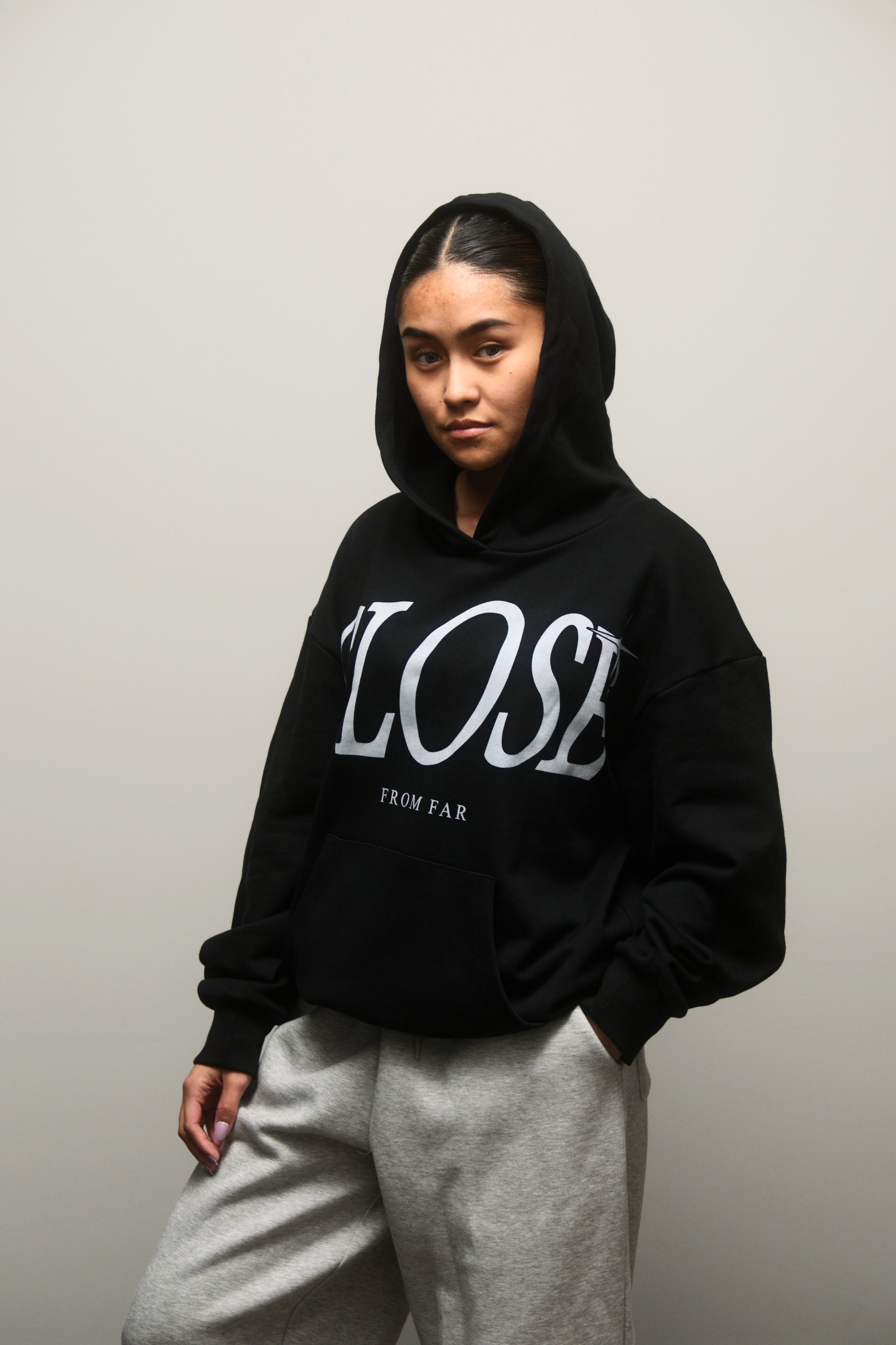 Female model wearing a Two Stars Close From Far Black Hoodie
