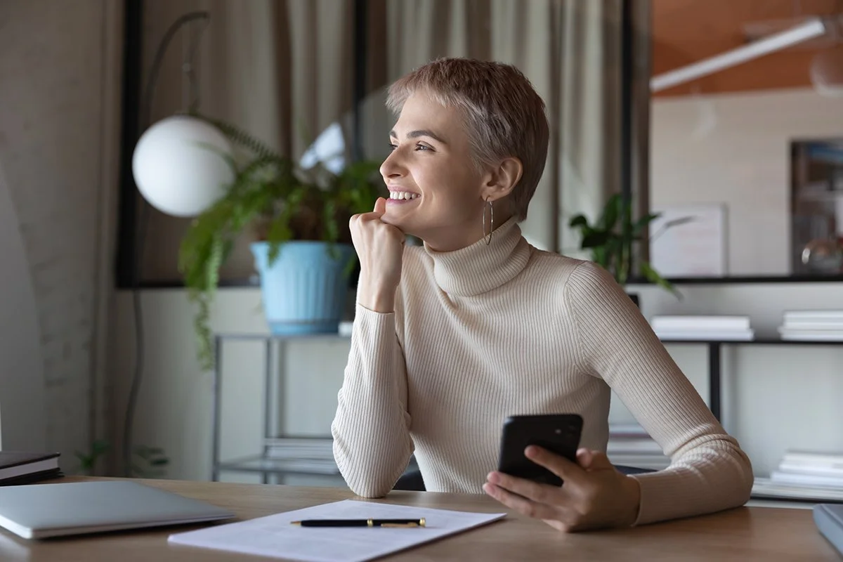 A middle aged white woman displaying a sense of happiness and wellbeing after sleep therapy that improves attention, memory, and problem-solving