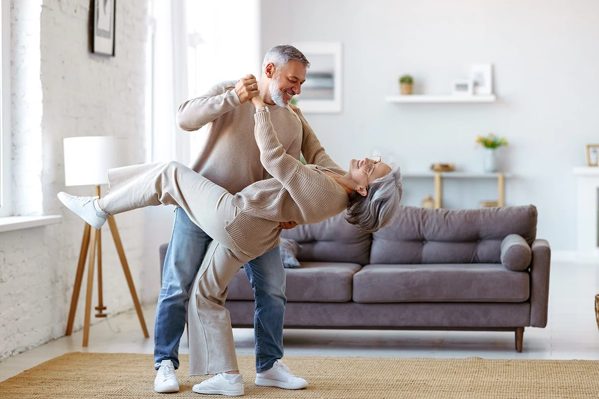 A white couple dancing together displaying a renewed sense of energy after sleep therapy