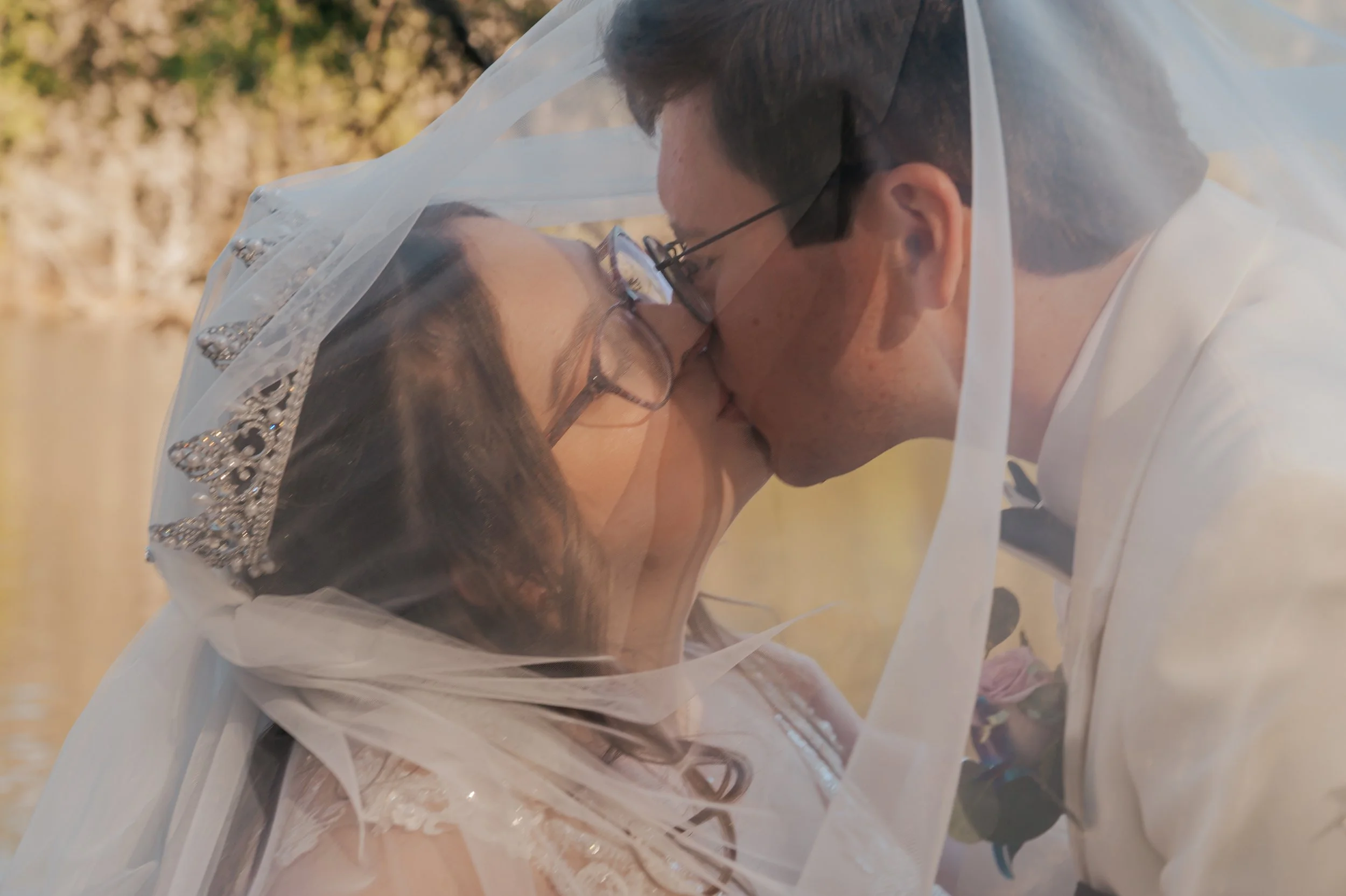 A couple exchanging a kiss during a wedding ceremony, seen through a veil. Johnstown Pennsylvania, Pittsburgh, New Jersey, elopement Photographer, elope