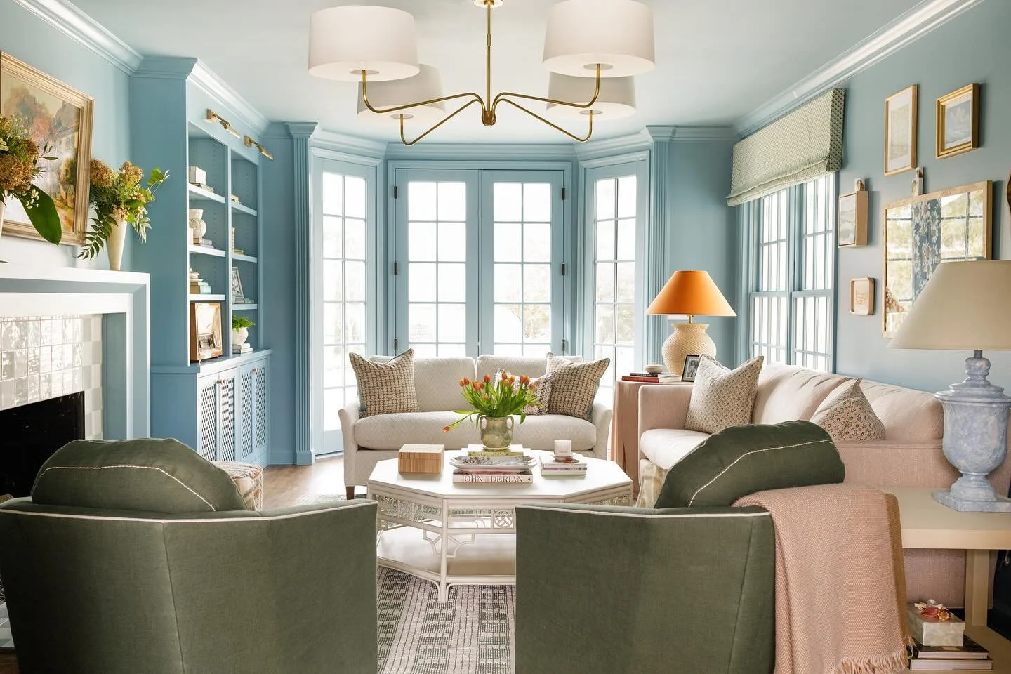 A room that feels ready for cozy season. The addition of deep saturated color, warm textiles, builtins, new doors, a layout centered around conversation, and intentional lighting turned this space from an awkward living space to an inviting room for 
