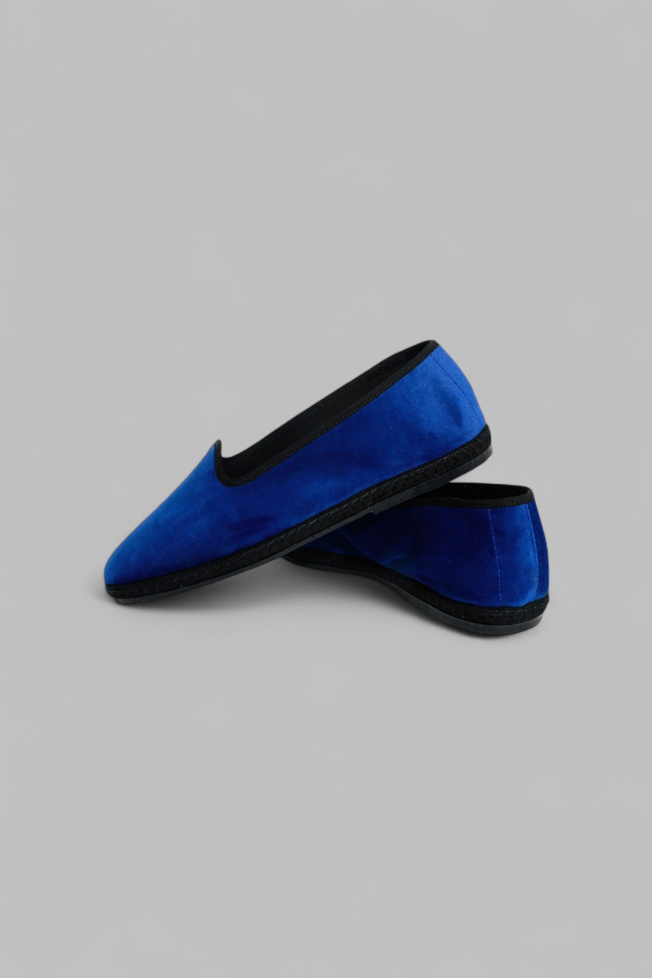 Overlapping pair of Gioia Royale velvet slippers in sapphire blue