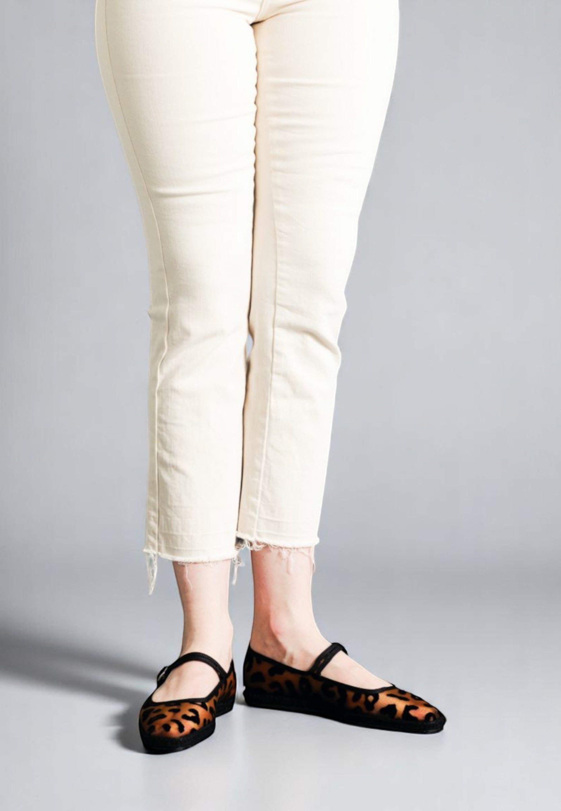 Front view of model in Jaguar print Aria Mary Janes, wild meets pared-back