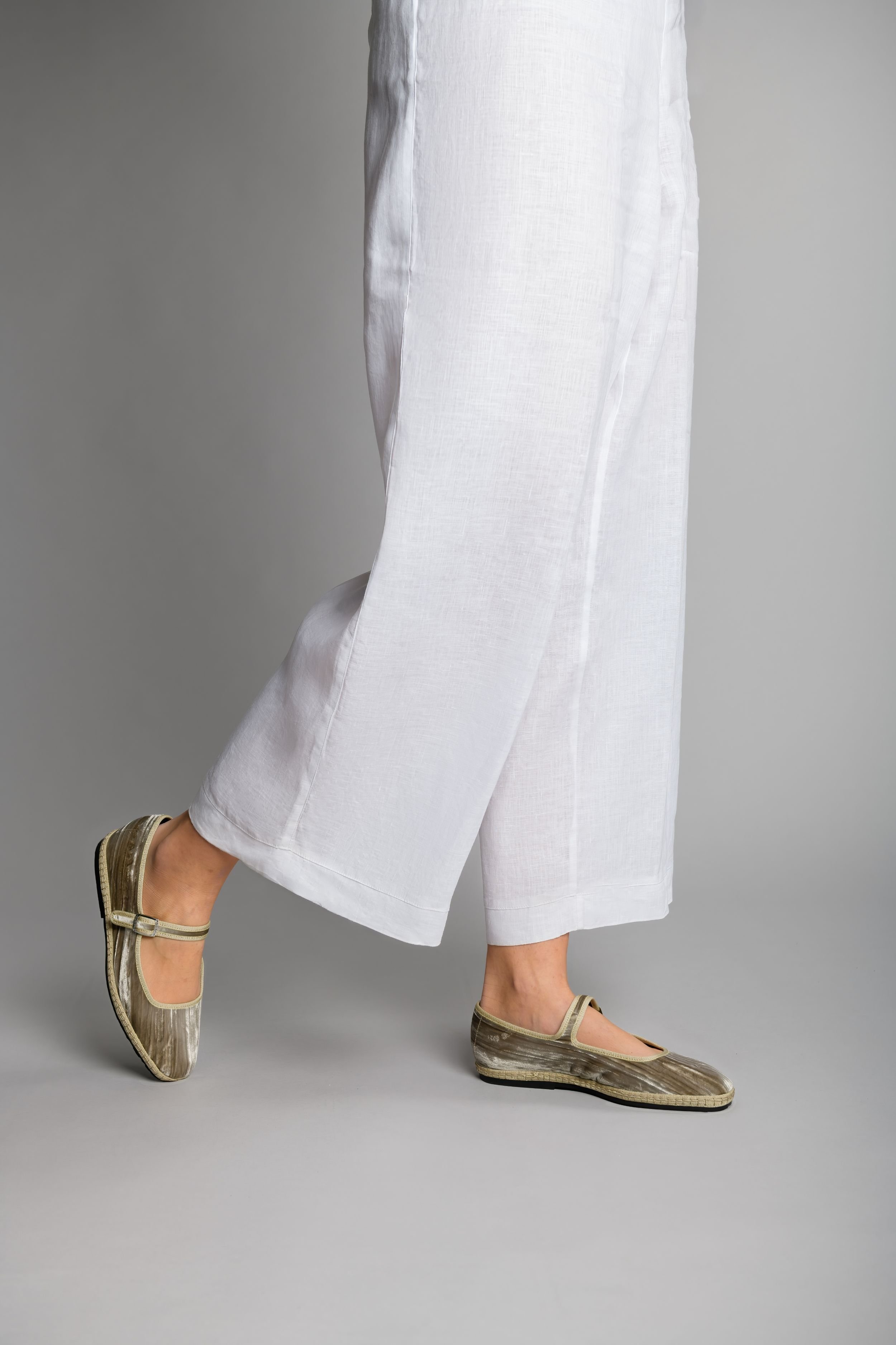 Model walking in Champagne velvet Mary Janes with square toe and soft shine
