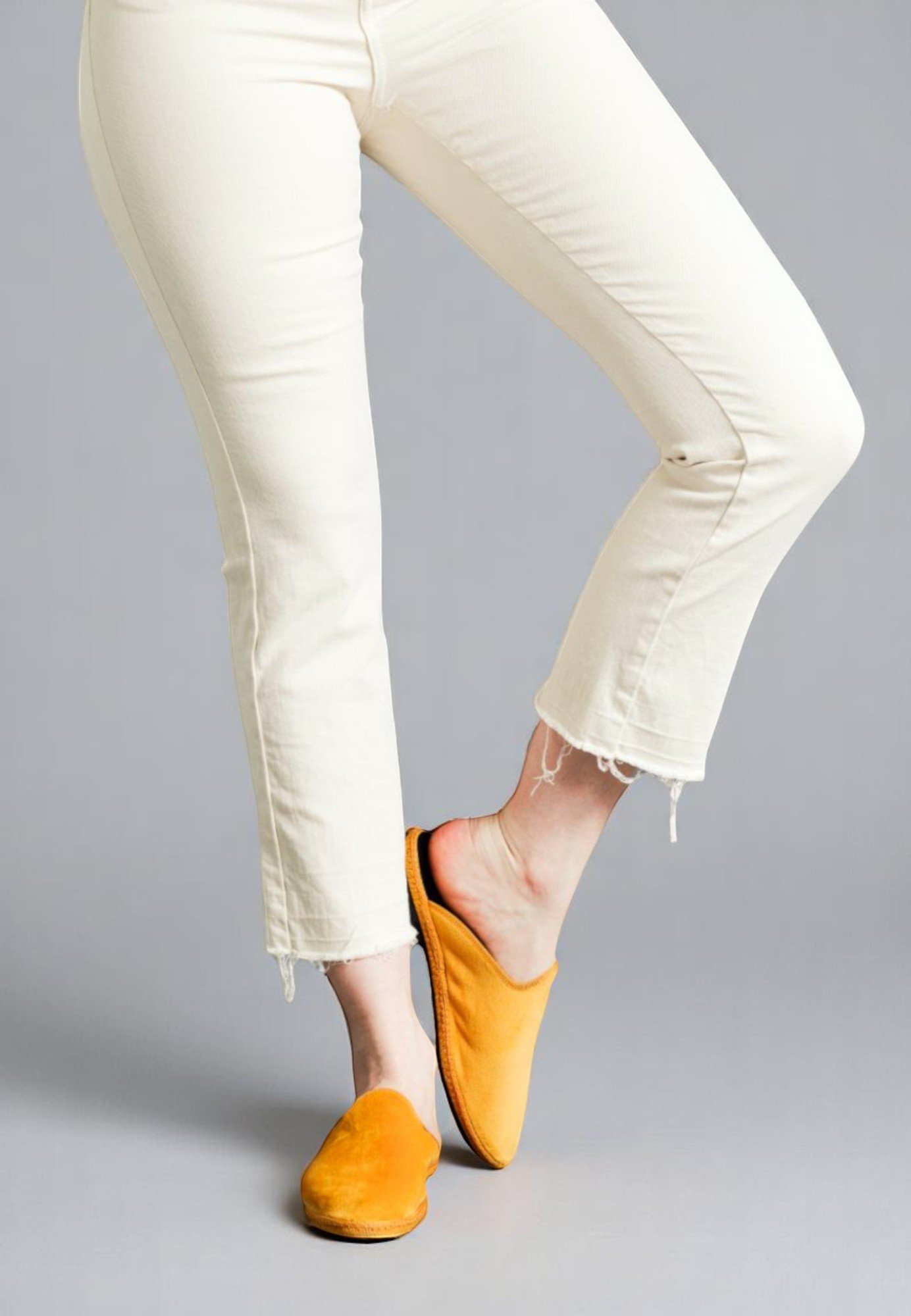 Lifted leg pose in Sole yellow velvet Solea handmade slippers; radiant and relaxed