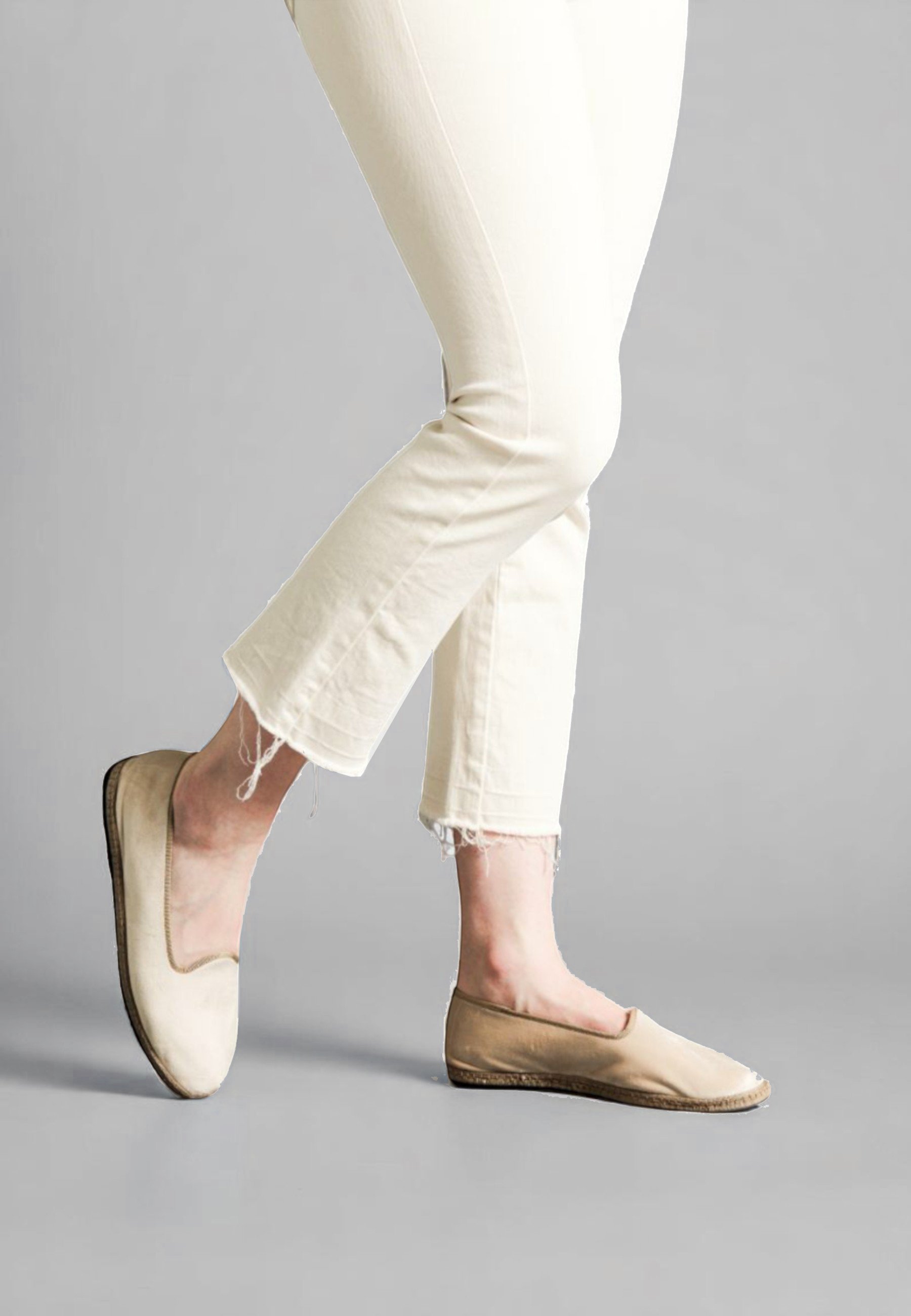 Side step of model in Dunes velvet Gioia slippers, walking in minimal denim