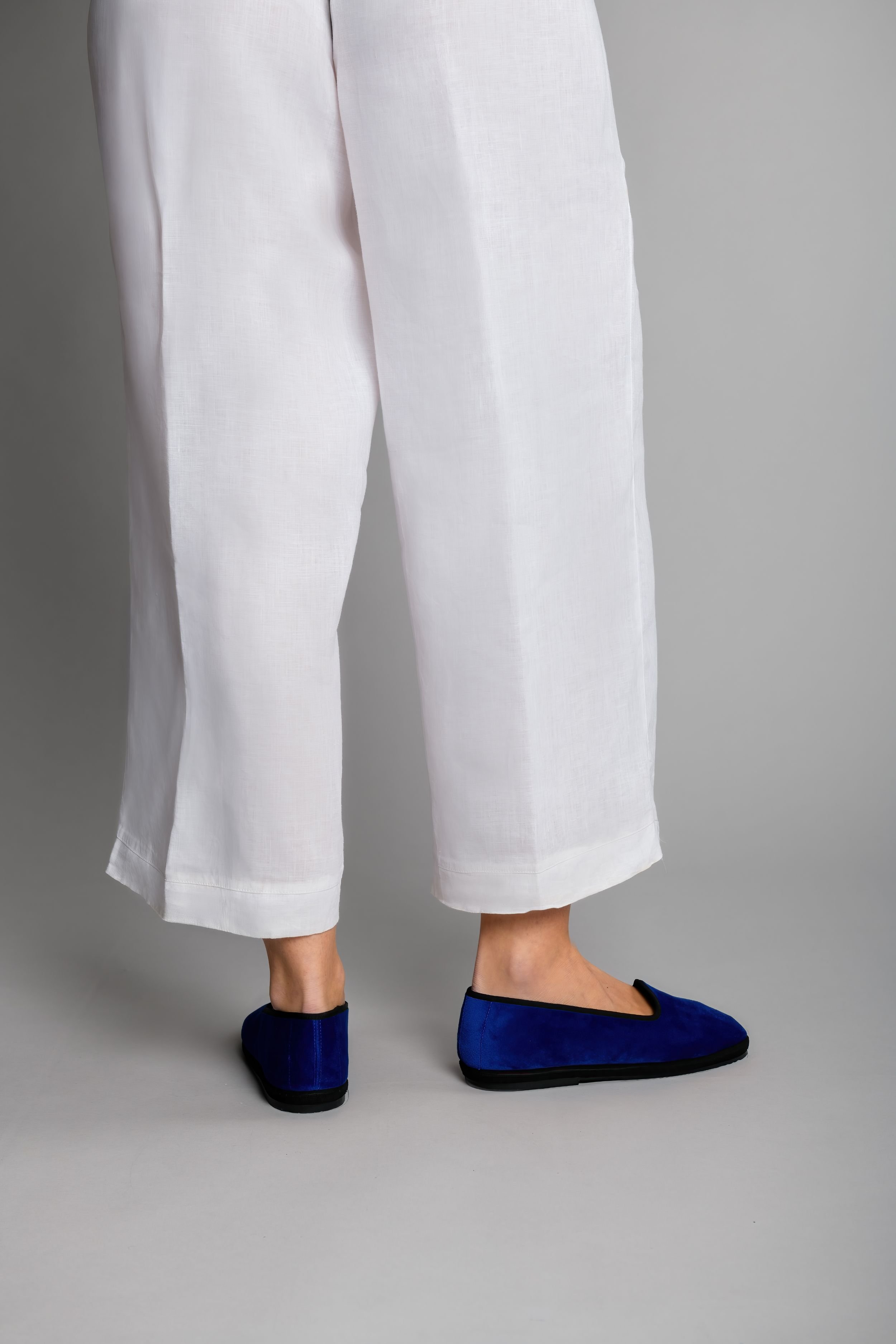 Back view of Gioia Royale slippers styled with white linen pants