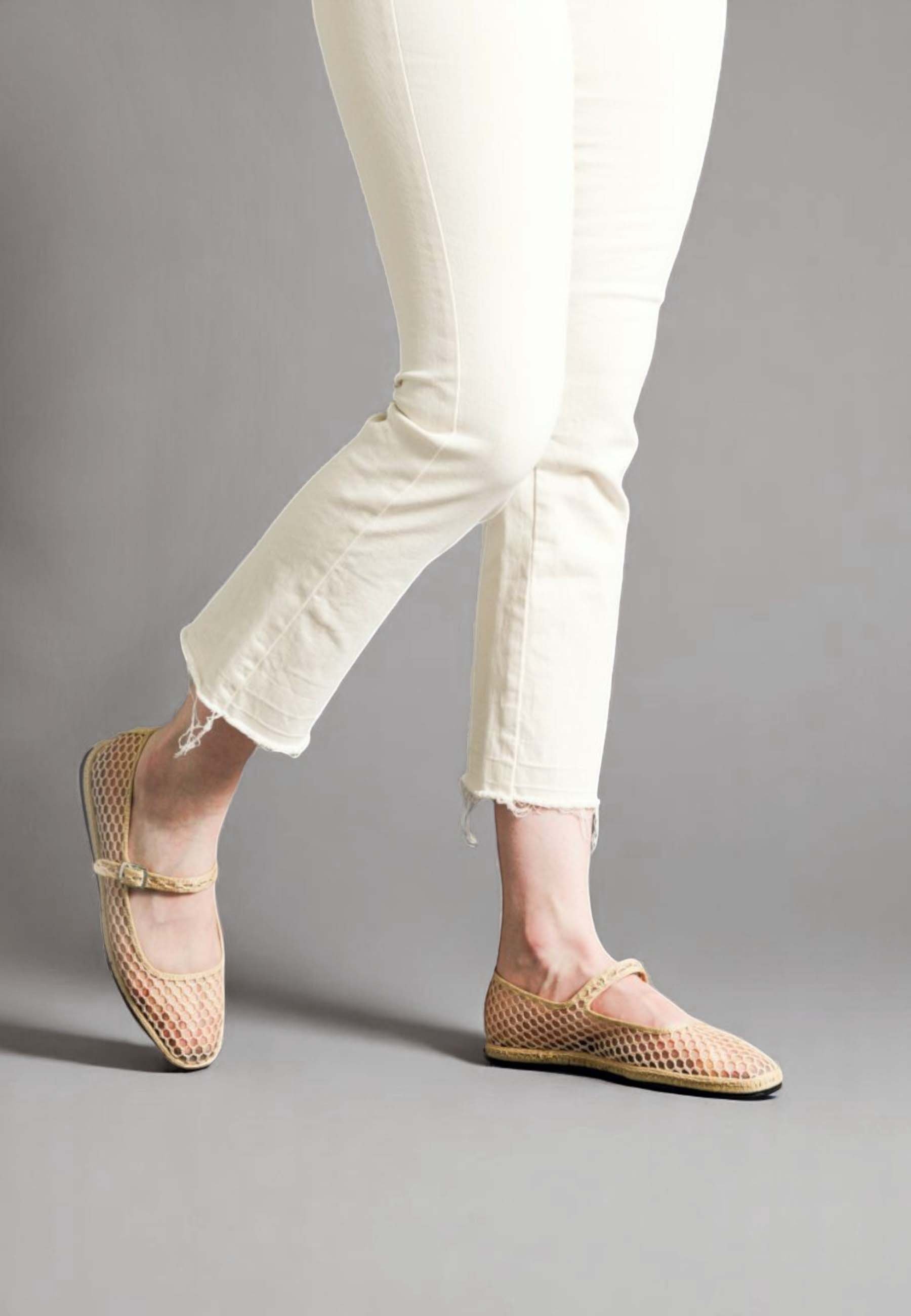 Walking view of Aria in Nude Net, showing movement and side profile of the elegant and fashionable mesh italian slipper