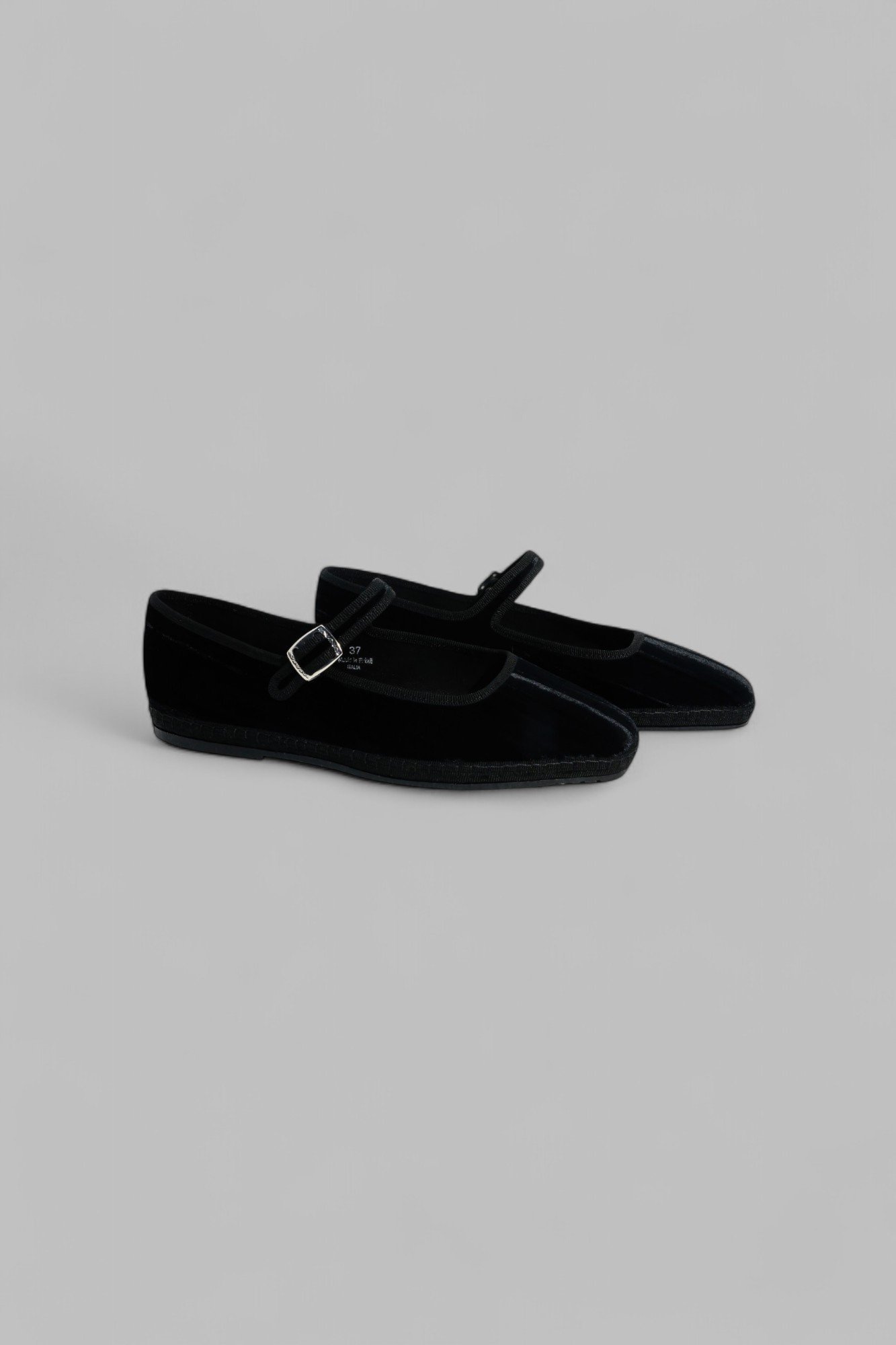 Pair of black velvet Mary Jane with tonal grosgrain trim, side view