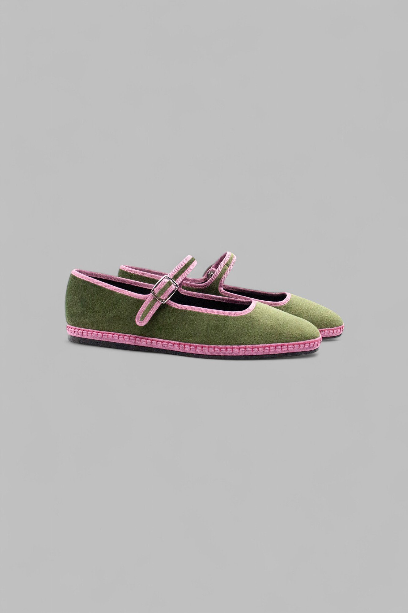 Side view of moss velvet Mary Jane shoe pair with pink trim