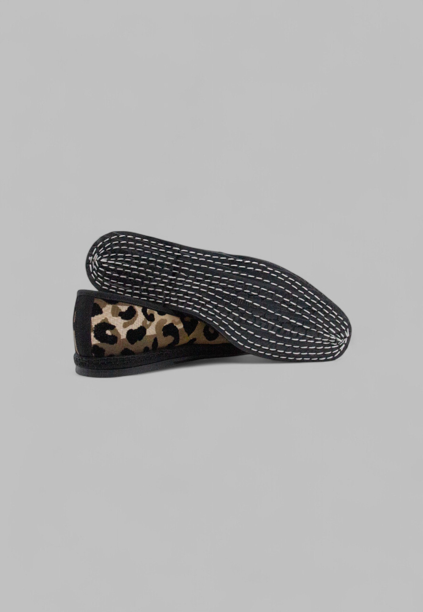 Underside view of Aria Jaguar flat showing hand-stitched rubber sole