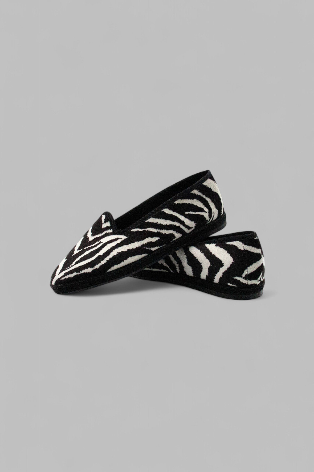 Overlapping pair view of Gioia Zebra vegan velvet slippers