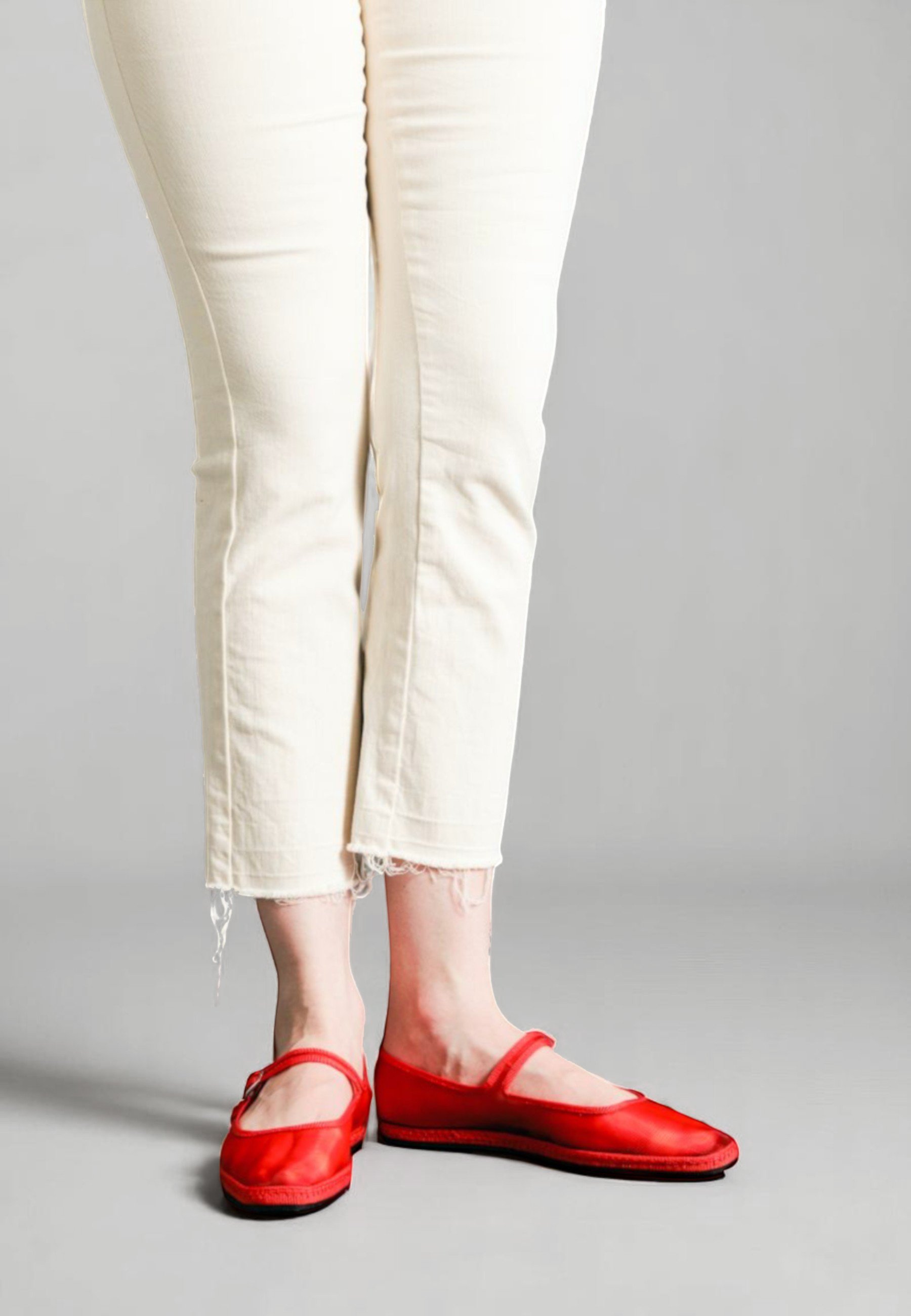 Front view of model in Flame red mesh, in the Aria Mary Jane silhouette, wearing ivory denim