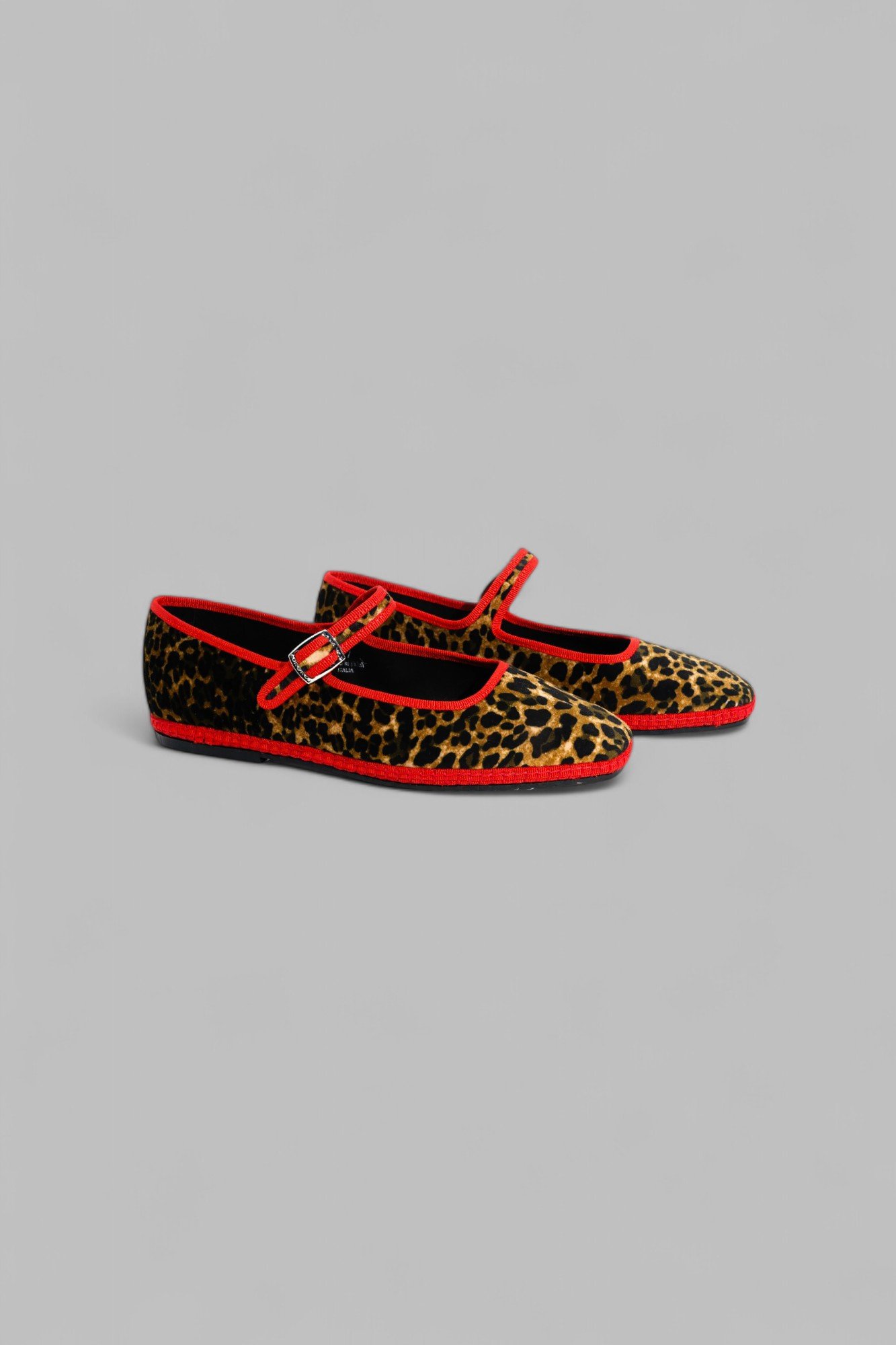 Pair of Jungle Mary Janes in leopard velvet with red piping, shown from the side