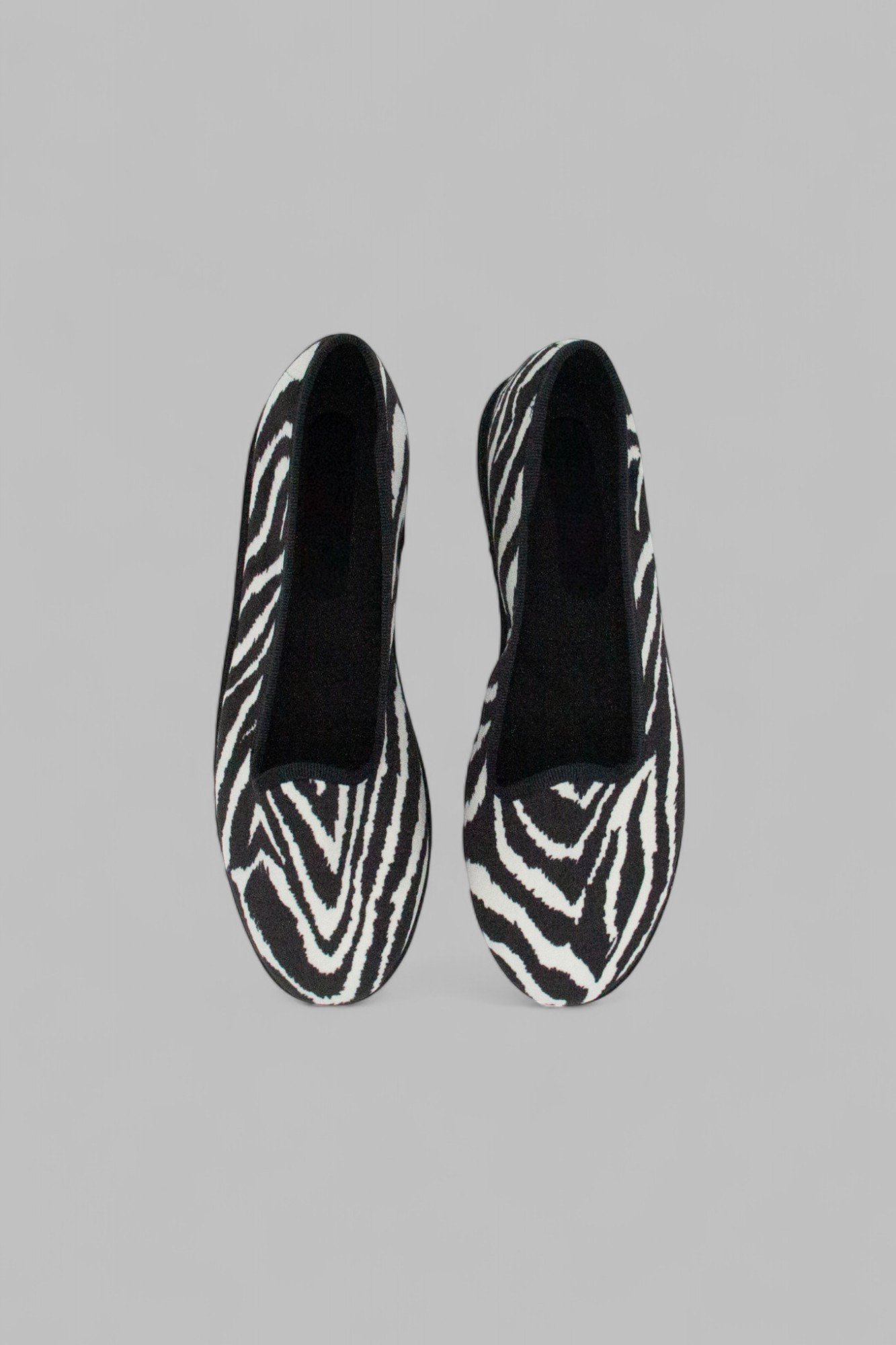 Top view of Gioia Zebra slippers showing soft black interior footbed