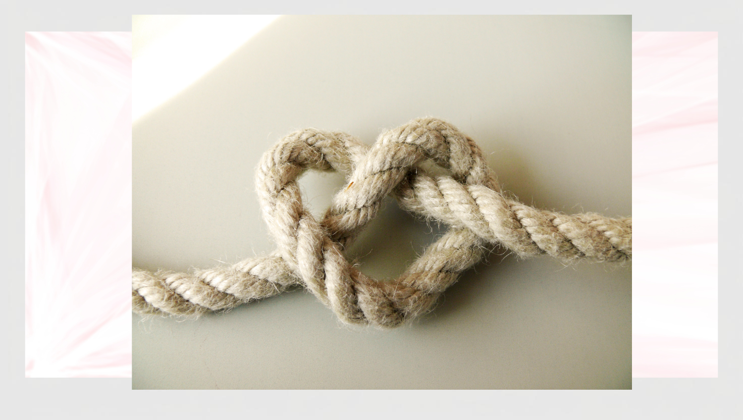 Rope tied in a heart-shaped knot on a light background