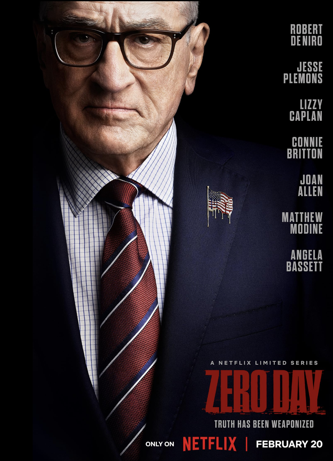 Close-up of an older man with gray hair, glasses, and a serious expression wearing a suit, tie, and American flag lapel pin, promotional poster for the Netflix series 'Zero Day'.