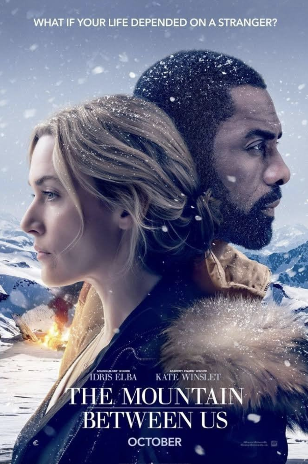 A movie poster for 'The Mountain Between Us' featuring Idris Elba and Kate Winslet against a snowy mountain landscape with falling snow, with the tagline 'What if your life depended on a stranger?'