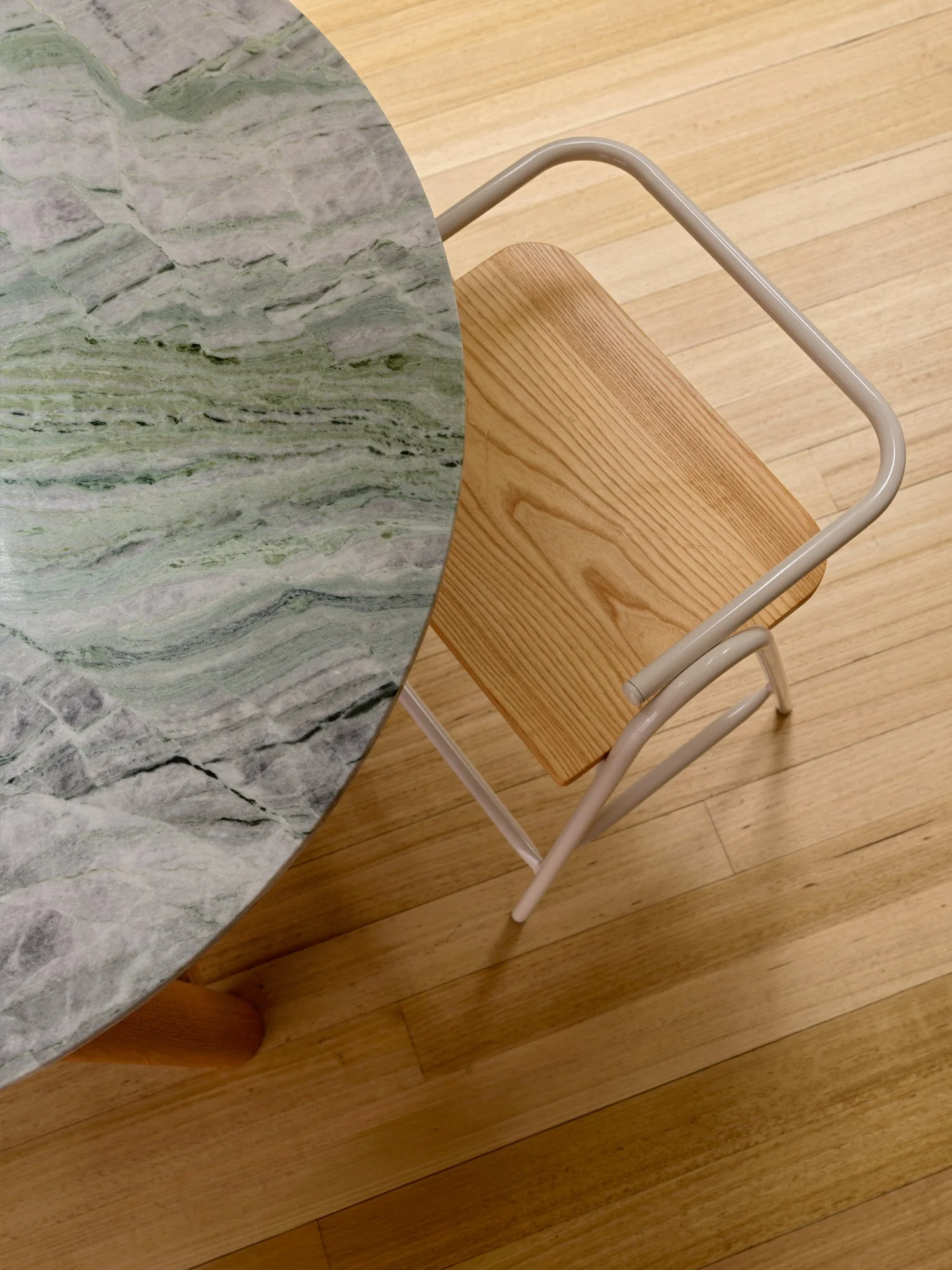 Detail of the curved stone kitchen island and timber chair at Northcote Extension.