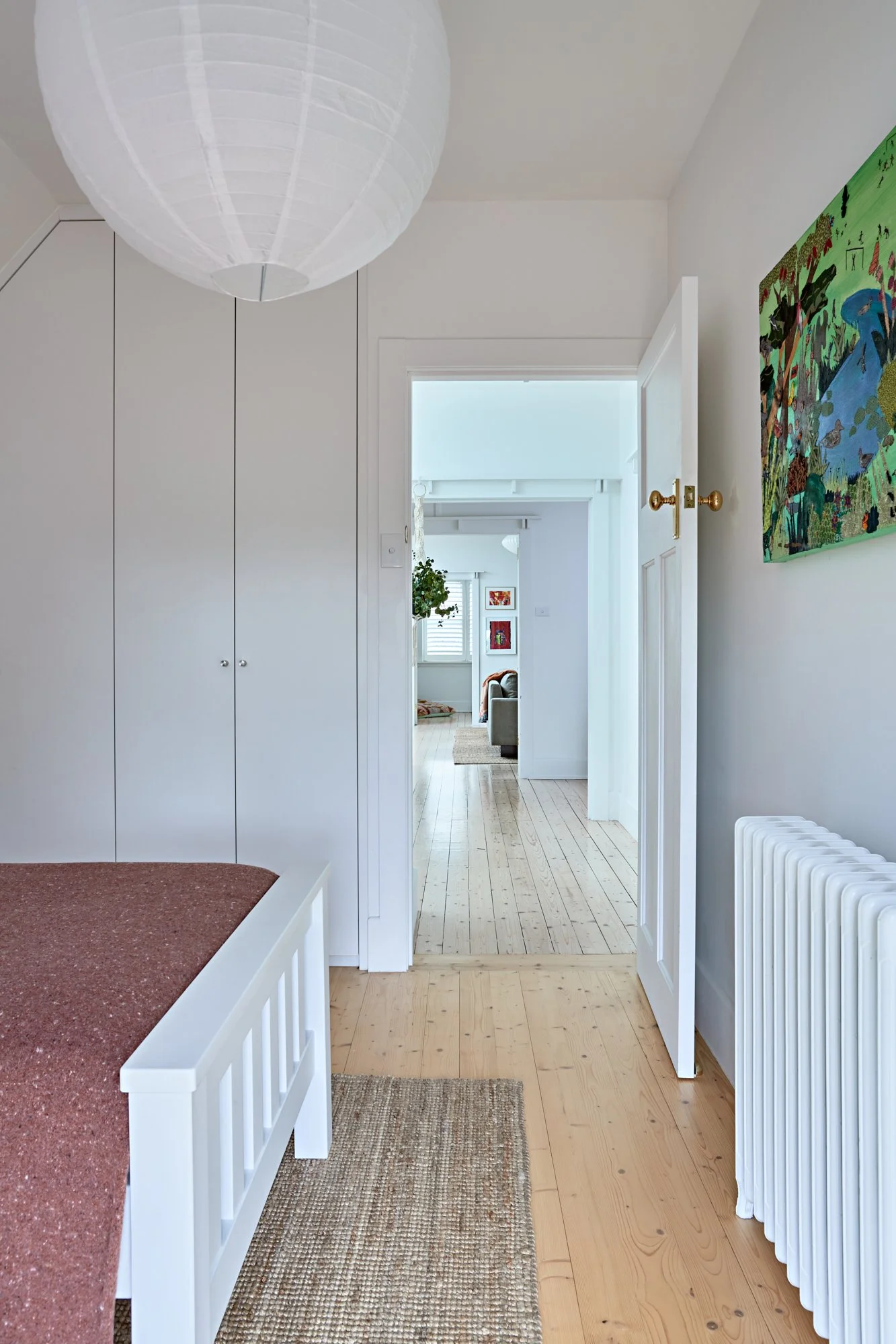 Upstairs bedroom with built-in storage and original timber floors at Adella Court, Elwood.