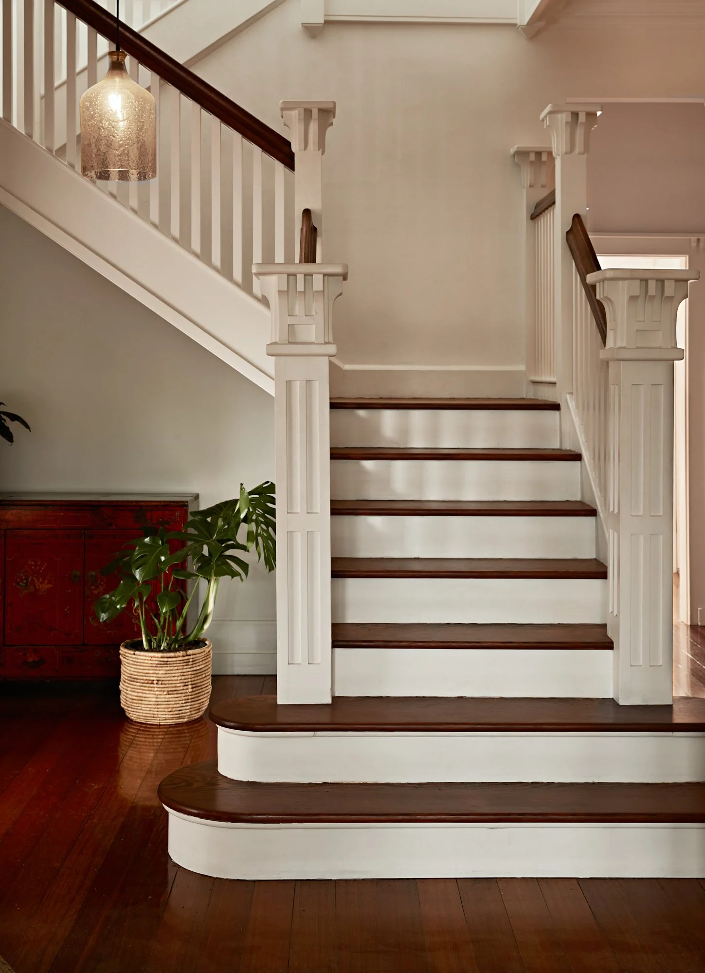 Original timber staircase with white balustrade and period detailing at Adella Court, Elwood.