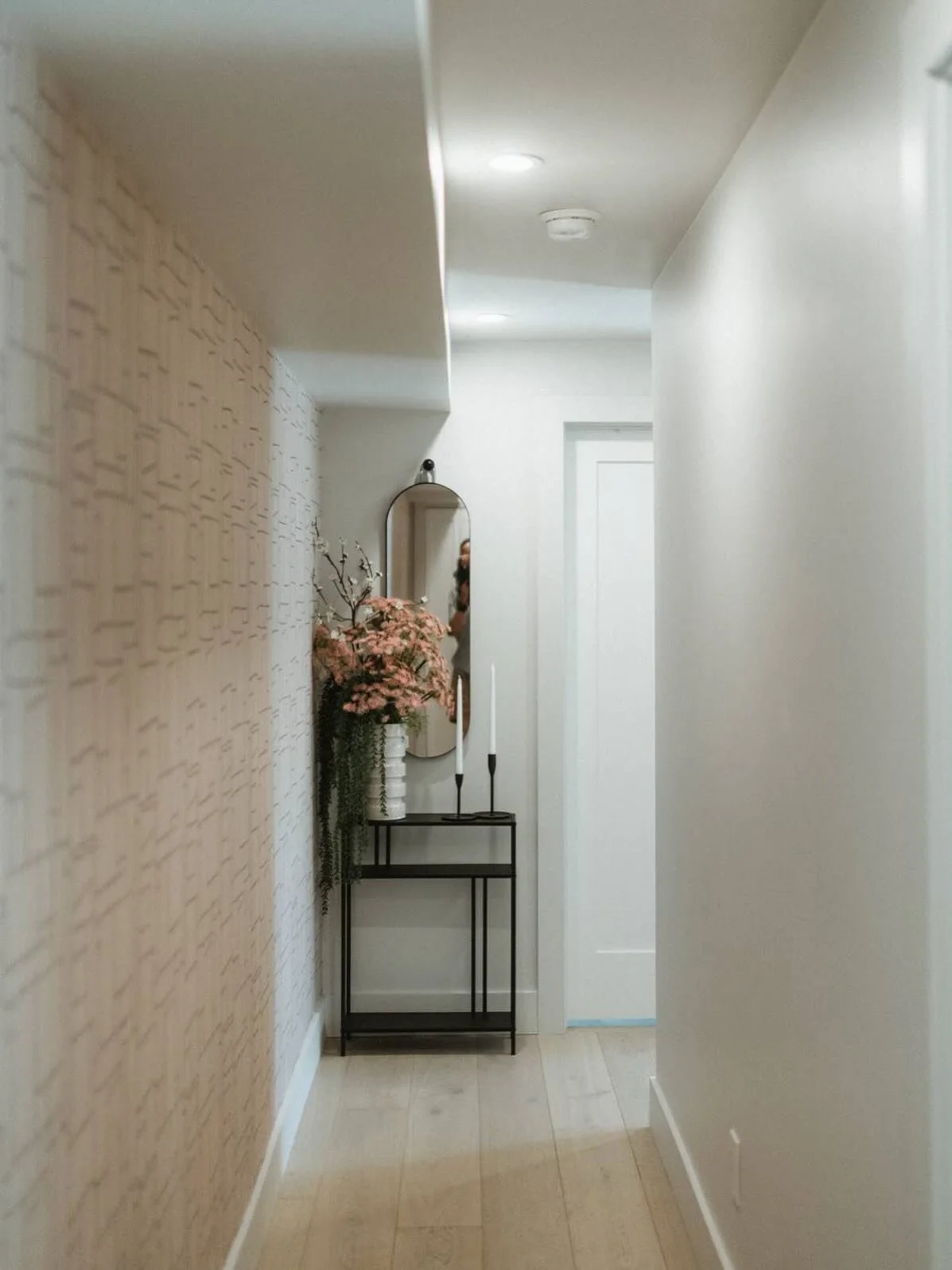 Boring hallway? Try a textured wallpaper. This can be a great alternative to picture frames in high traffic, narrower spaces, or a great way to elevate your walls when paint alone isn&rsquo;t enough. 

This Utah basement was fixed with a neutral &amp