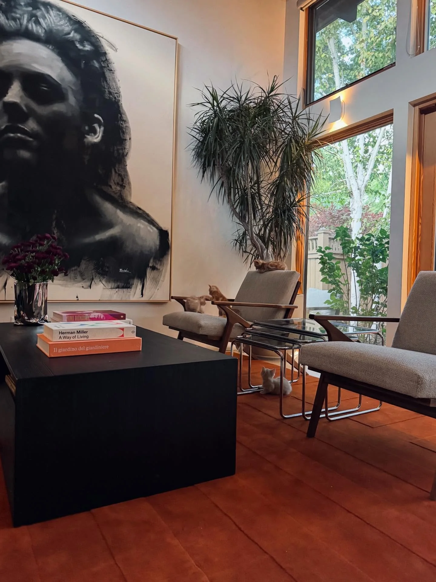 No parlor is complete without a burnt orange rug paired with 4 oranger foster kitties.

Chairs &amp; Coffee Table: @crateandbarrel
Rug: @nordicknots 
Nesting Tables: MCM Vintage @etsy
Chrome Vase: @huegahhome
Art: @brianwooden 
Pant: @cactusandtropic