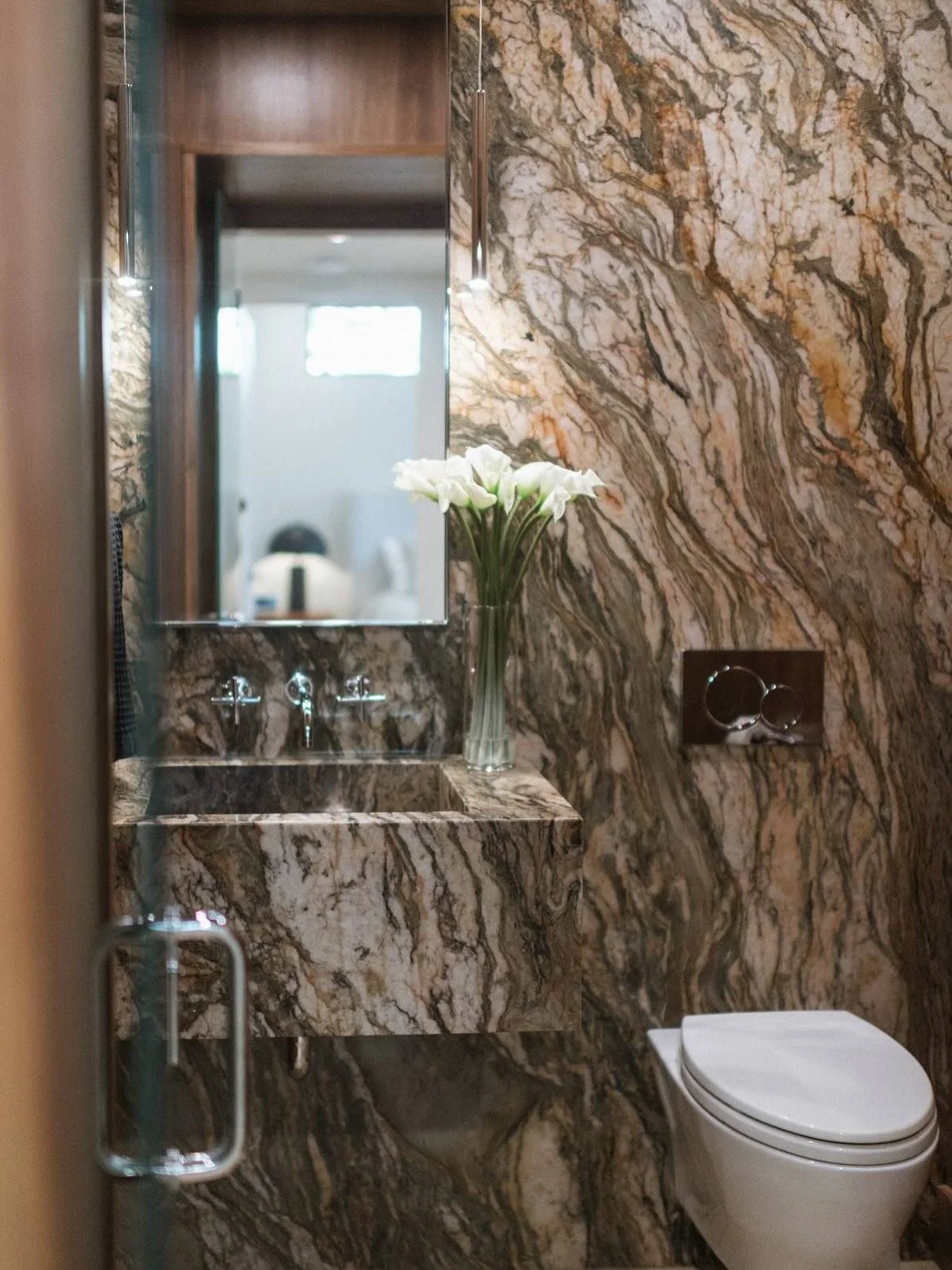 Powder room goals were achieved with this stunning slab of Fascination Quartzite as the dominate feature. The sink is seamlessly integrated into the accent wall to creat a cohesive look.
#NESTStudio #designslc #interiordesign #halfbath #neststudioslc