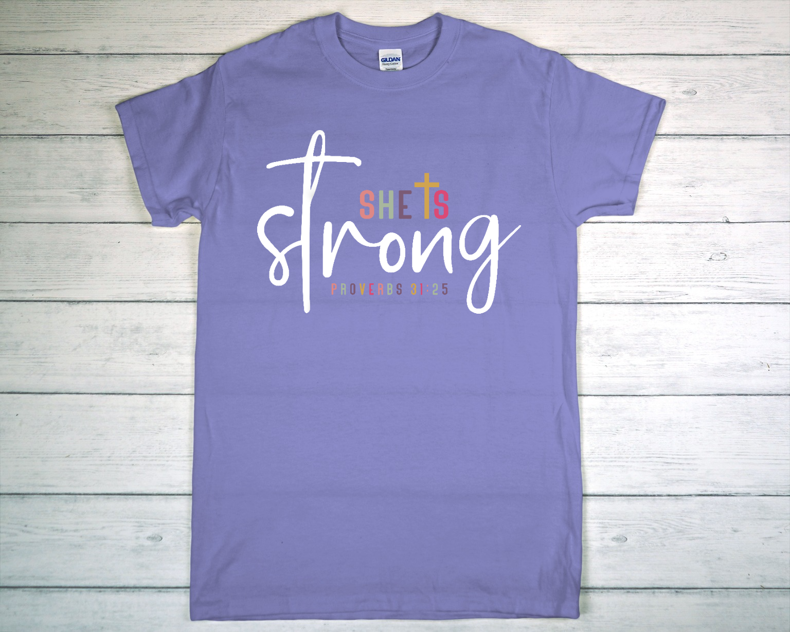 Lavender T-Shirt on Rustic Wooden Surface with Brand Label.png