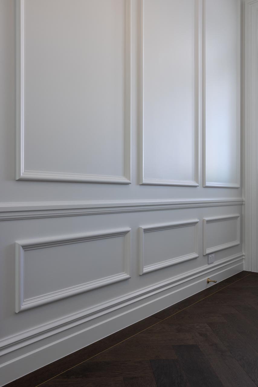 Detail of white panelled walls using colonial mouldings.