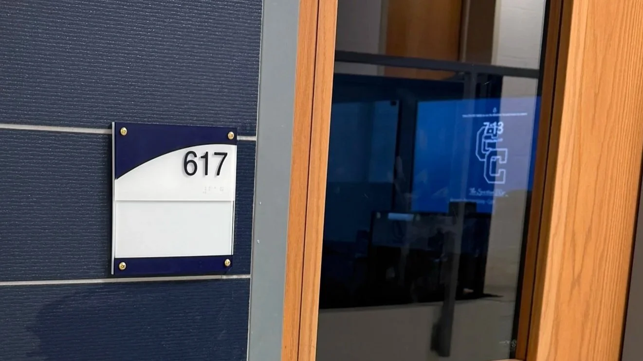 Building entrance with the number 617 on a sign and a glass door.