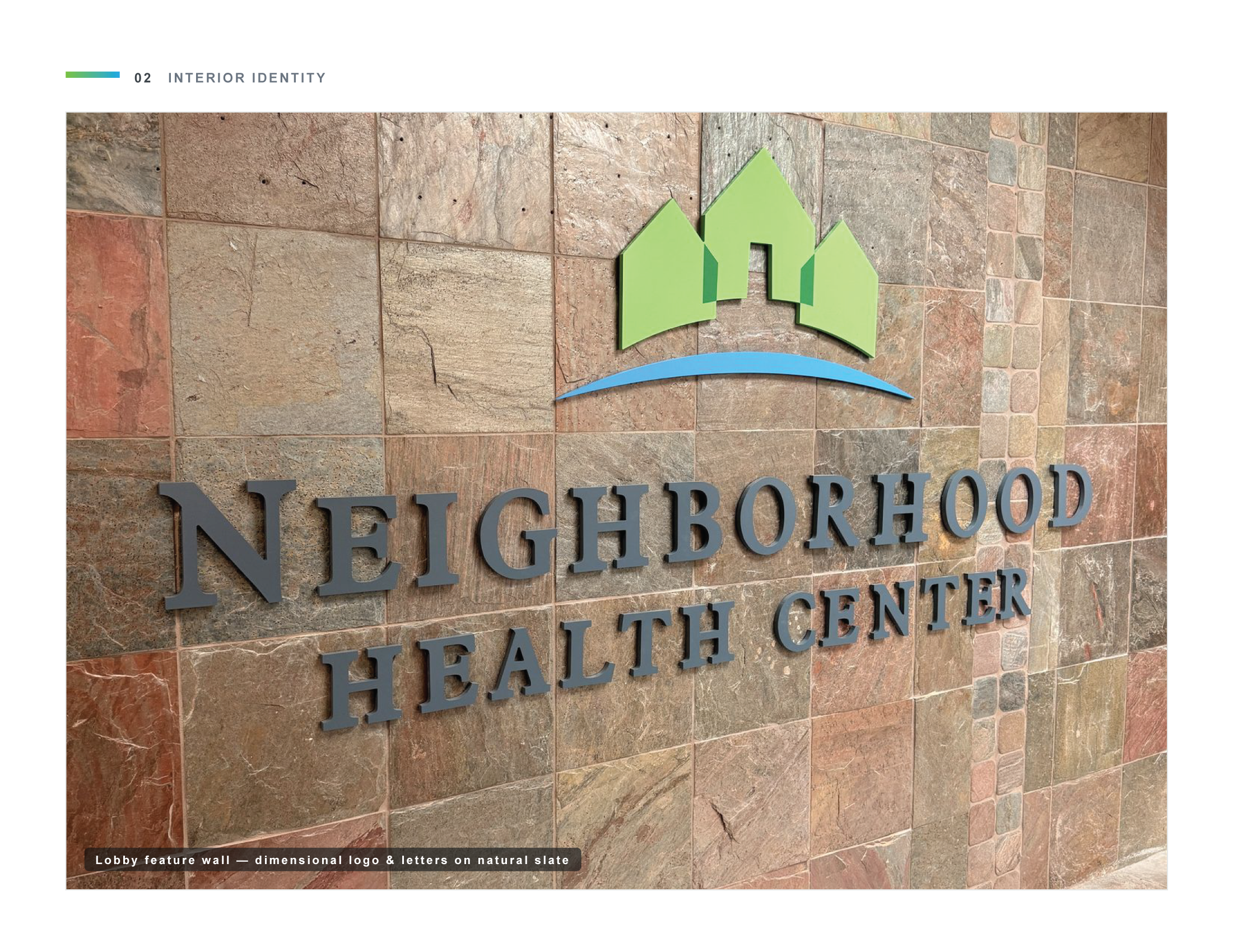 Lobby feature wall with dimensional logo and letters on natural slate