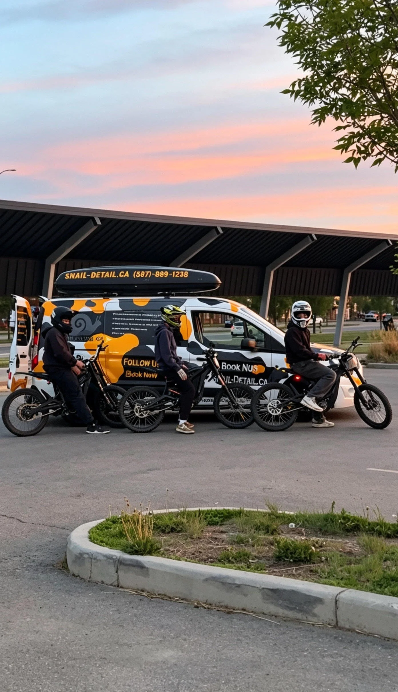 Three people on bikes in front of a vehicle with a sign advertising Snail Detail, parked under a shelter at sunset.