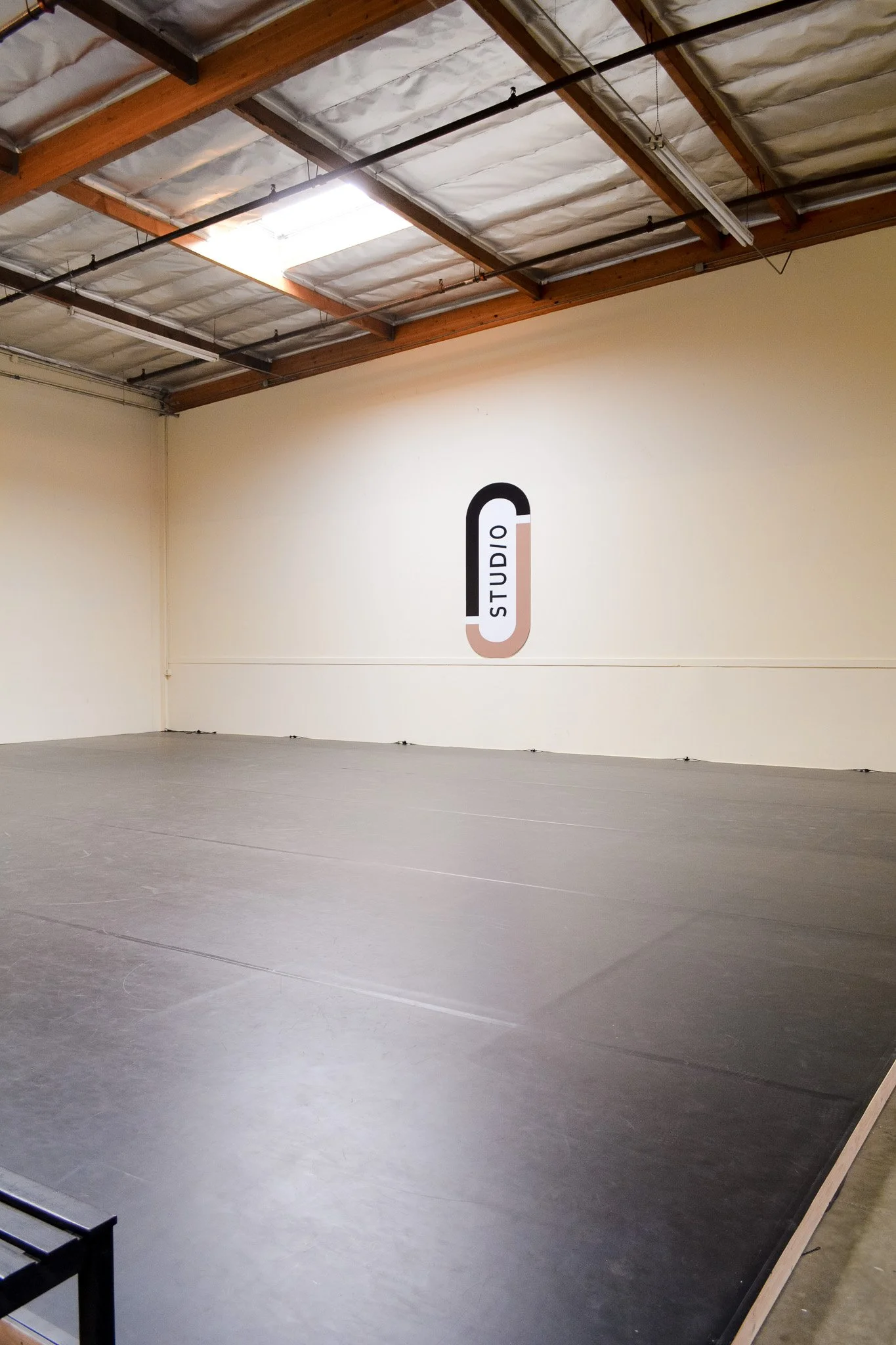 dance studio with a black floor, beige walls, Competitive dance studio in Brea and Fullerton