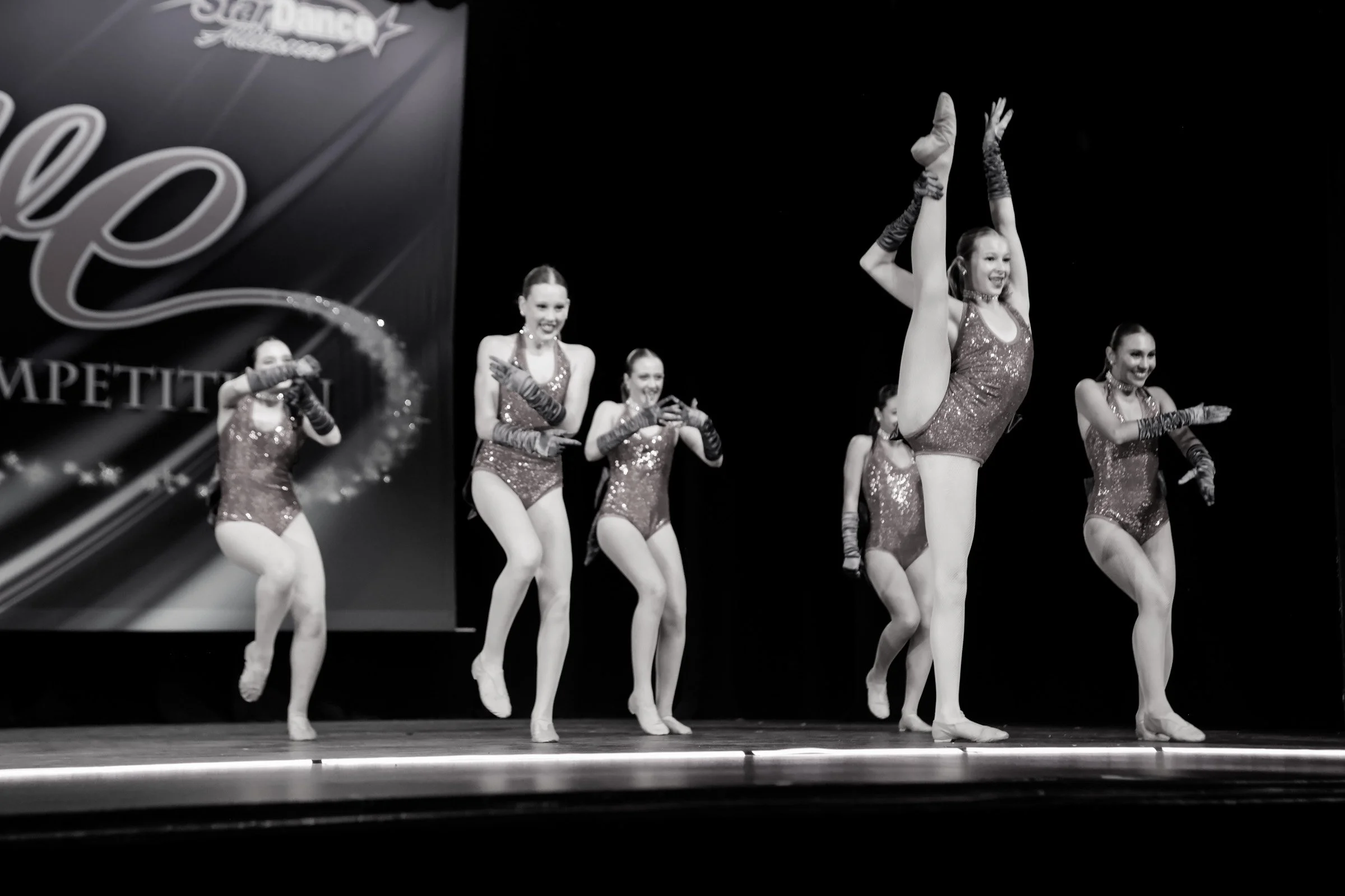 Group of dancers performing jazz choreography on stage during a dance competition-Studio-J-Dance-Collective-brea-fullerton-ballet-competition-team-dance-studio