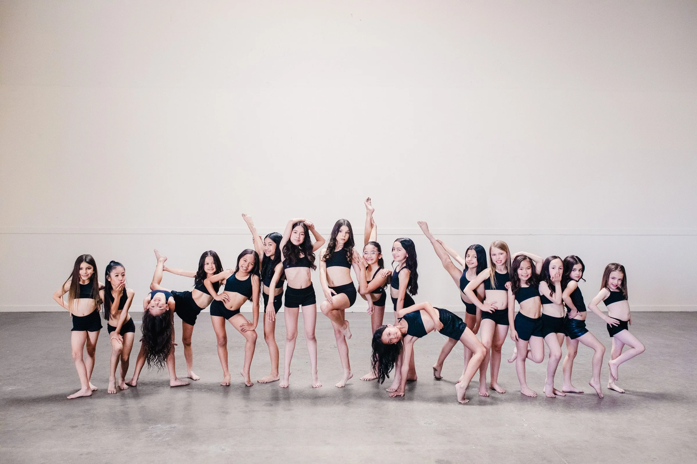 Group of competitive elementary school age and high school dancers in black in dance photography poses-Studio-J-Dance-Collective-brea-fullerton-ballet-competition-team-dance-studio