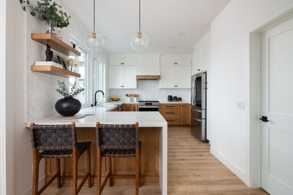 Modern white and wood kitchen with island, black accents, open shelving, and pendant lighting.