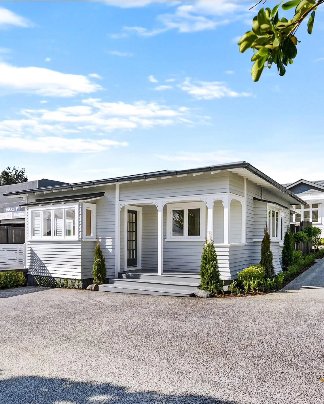 Repainted single-storey home exterior in light grey, Auckland