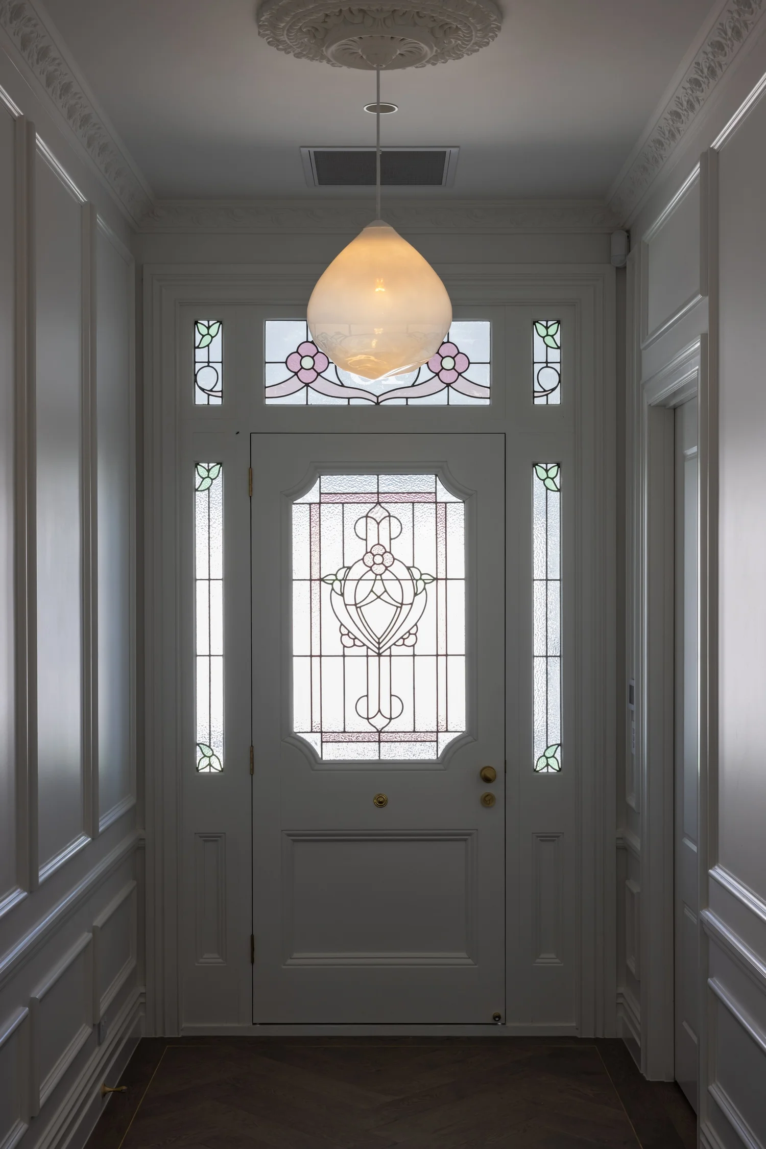 Villa entrance with stained glass door, interior painted by Key Painting