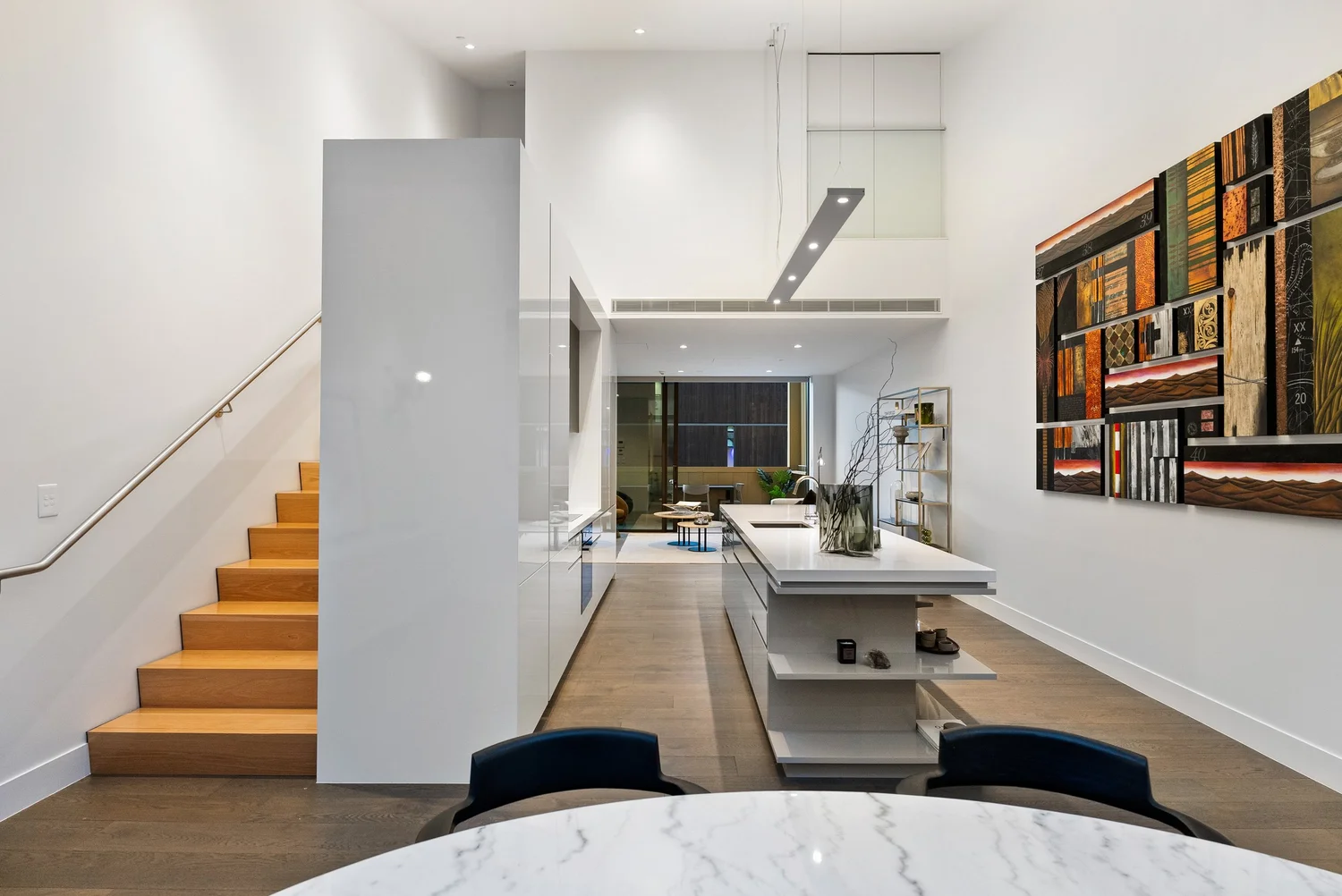 Interior painting of an open-plan kitchen and stairwell in an Auckland home by Key Painting