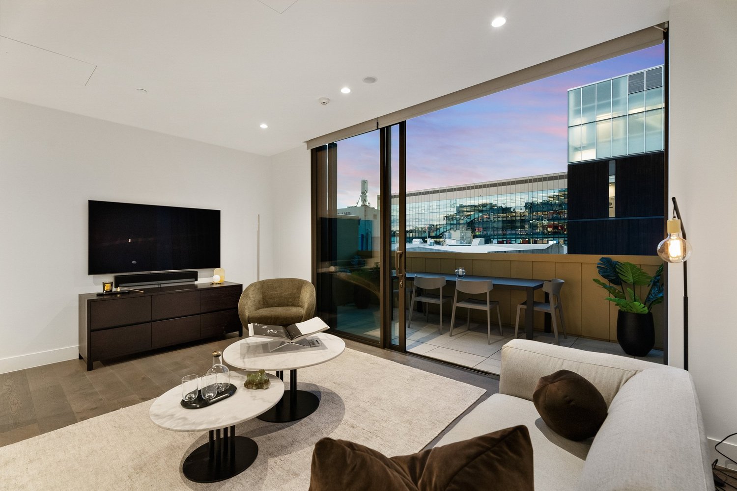 Painted apartment living room with balcony views at sunset, Auckland