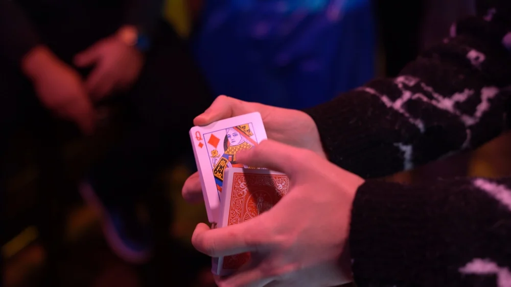 Strolling magician performing close-up magic at a St. Louis private party
