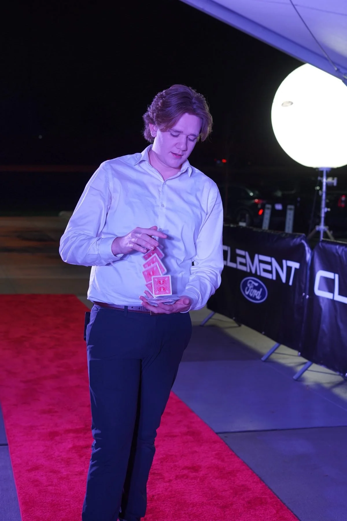 St. Louis corporate magician Gage Barnett performing card magic at a Clement Ford event