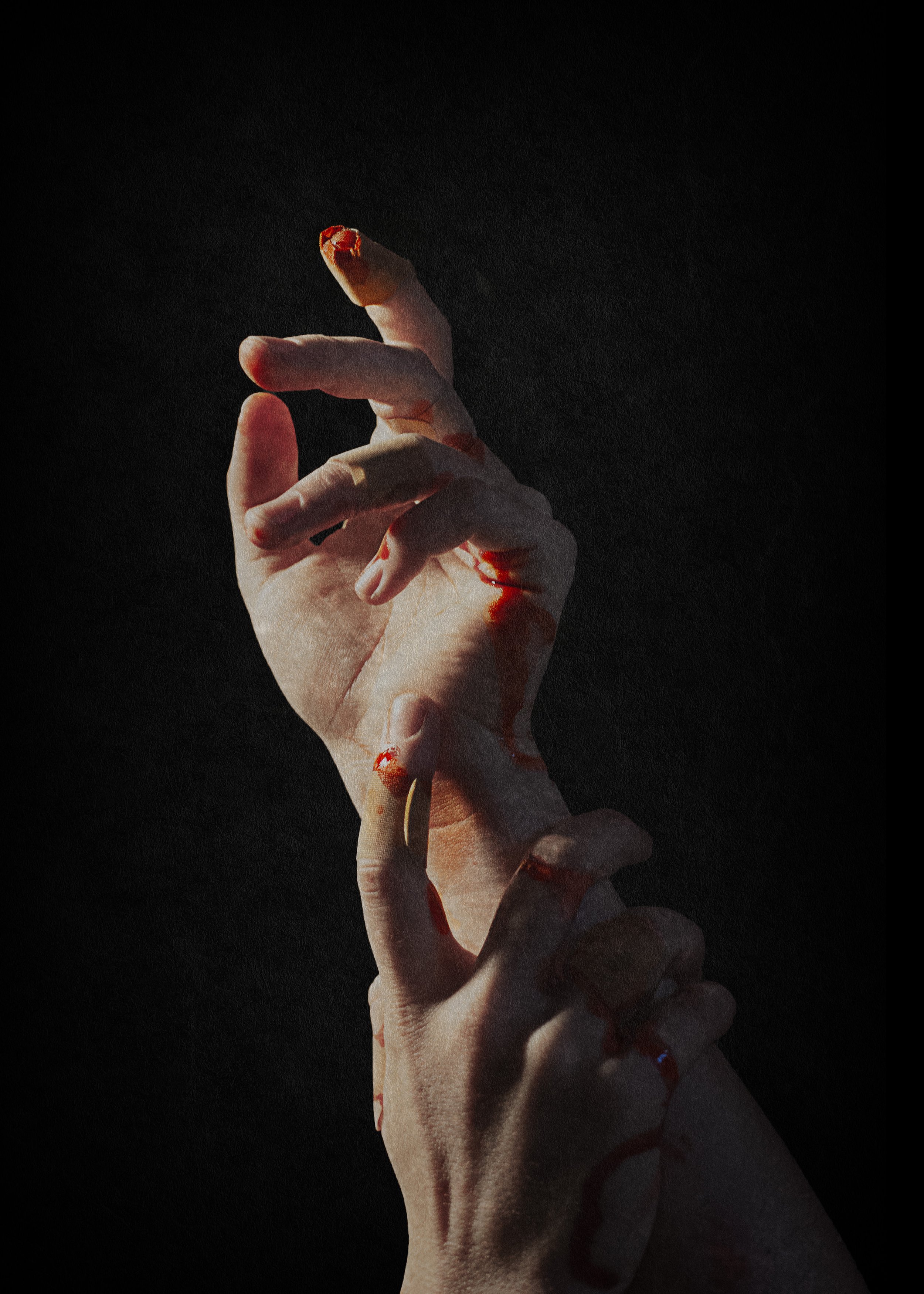Close-up of hands with bleeding wounds on fingertips against dark background.