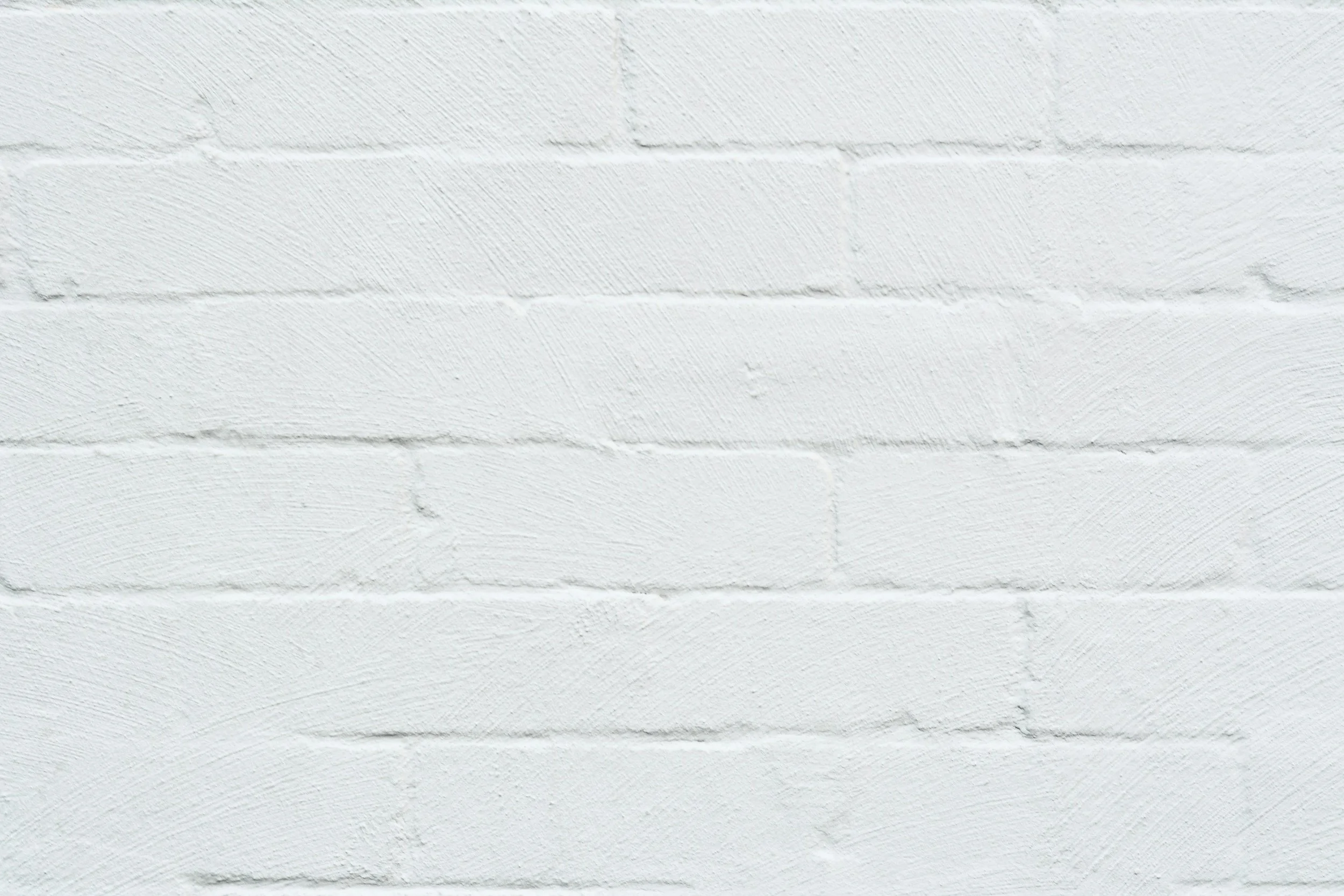 White painted brick wall with textured surface.