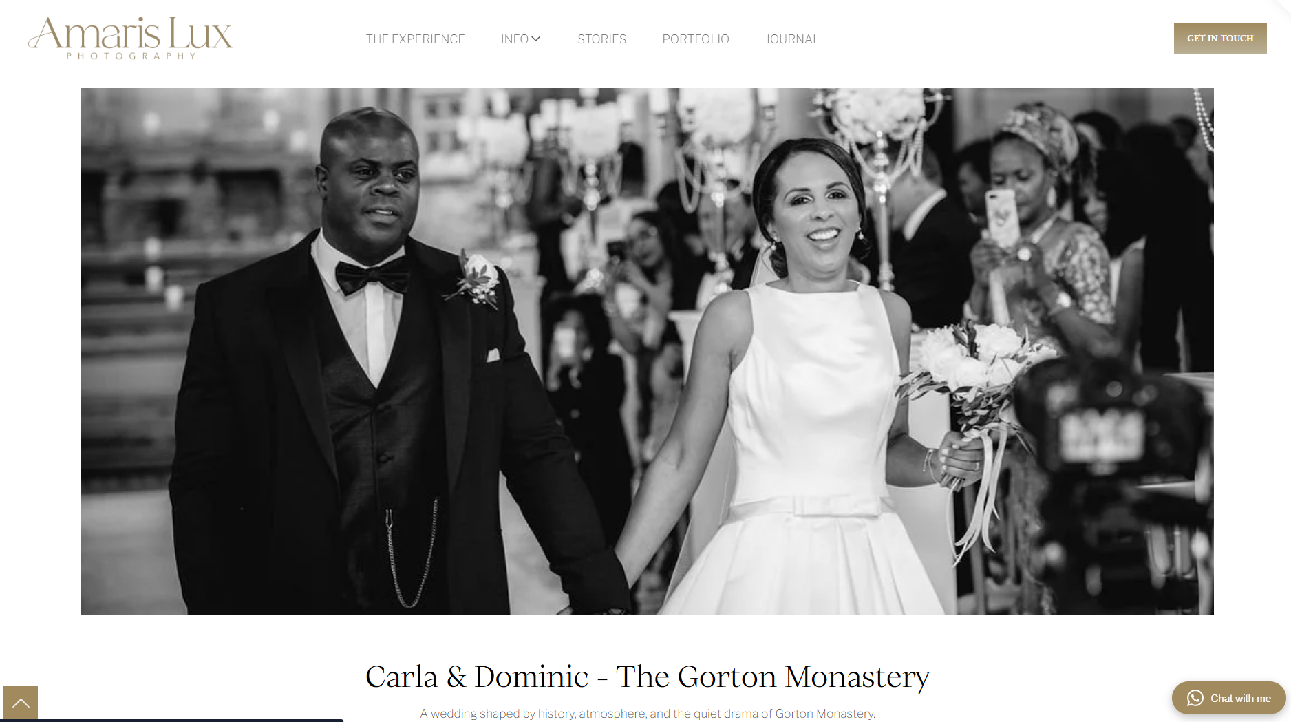 Black and white photo of a wedding ceremony at Gorton Monastery, featuring a smiling bride in a white dress holding a bouquet, and a groom in a tuxedo, with guests and a photographer capturing the moment in the background.
