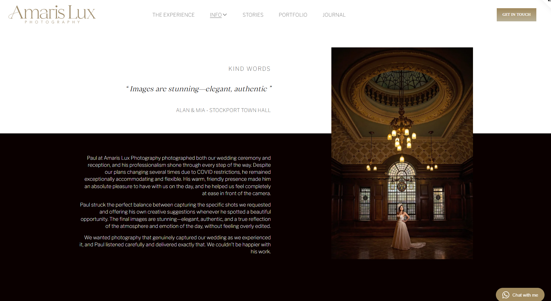 A woman in a wedding dress standing in a grand, historic hall with stained glass windows, wood paneling, and a high, decorated ceiling with lighting fixtures.