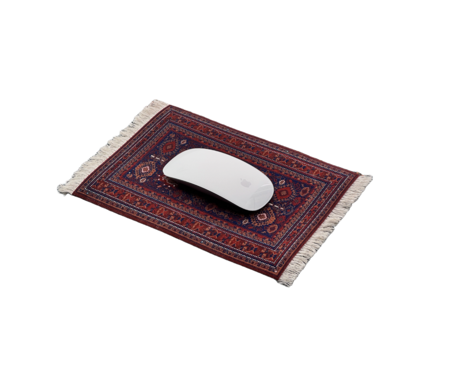 A white Apple Magic Mouse placed on a small Persian-style rug with intricate red, blue, and pink patterns and fringed edges.