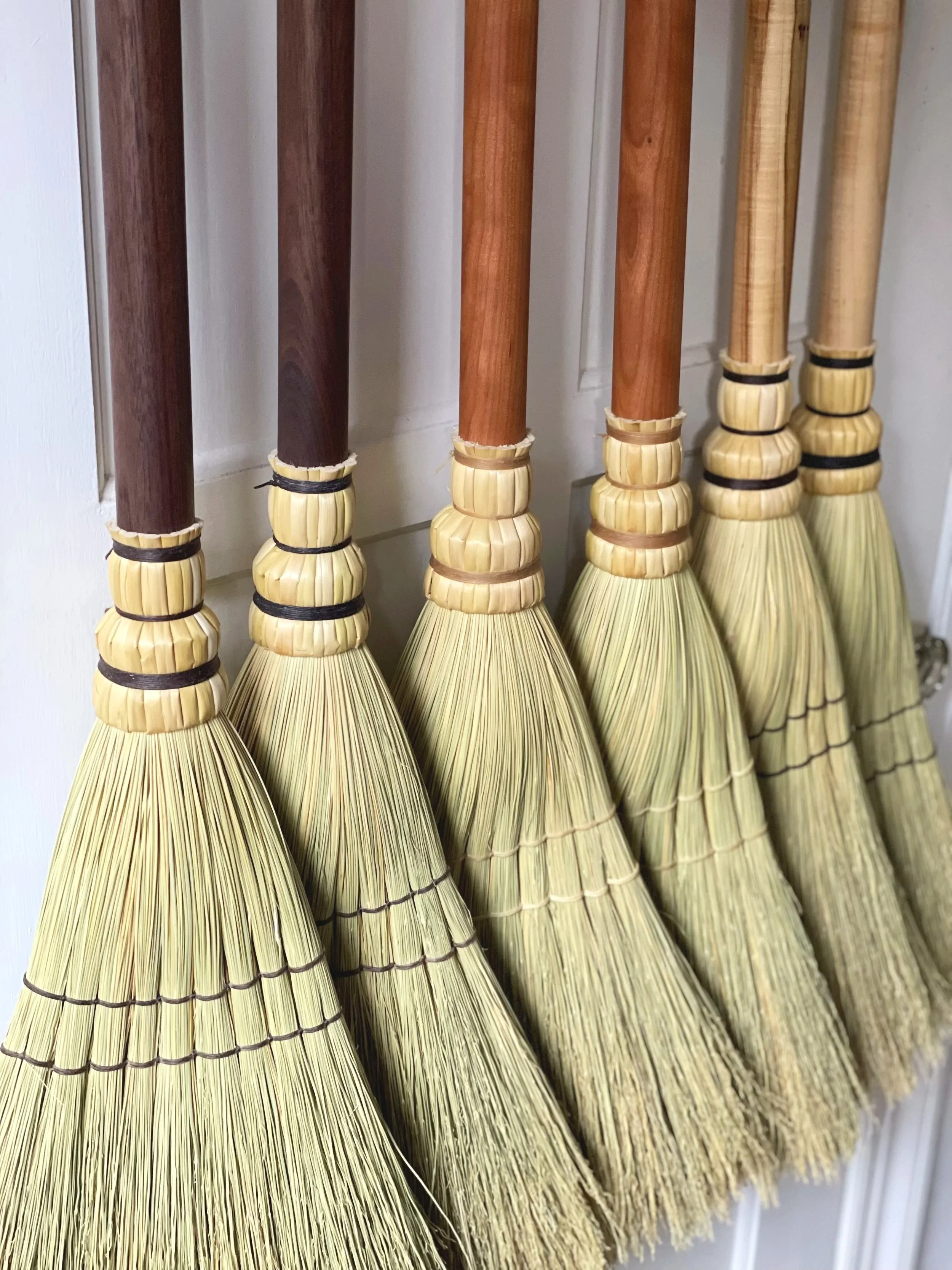 Handwoven house brooms using locally made handles by Han Studio hand turned on the lathe traditional craft